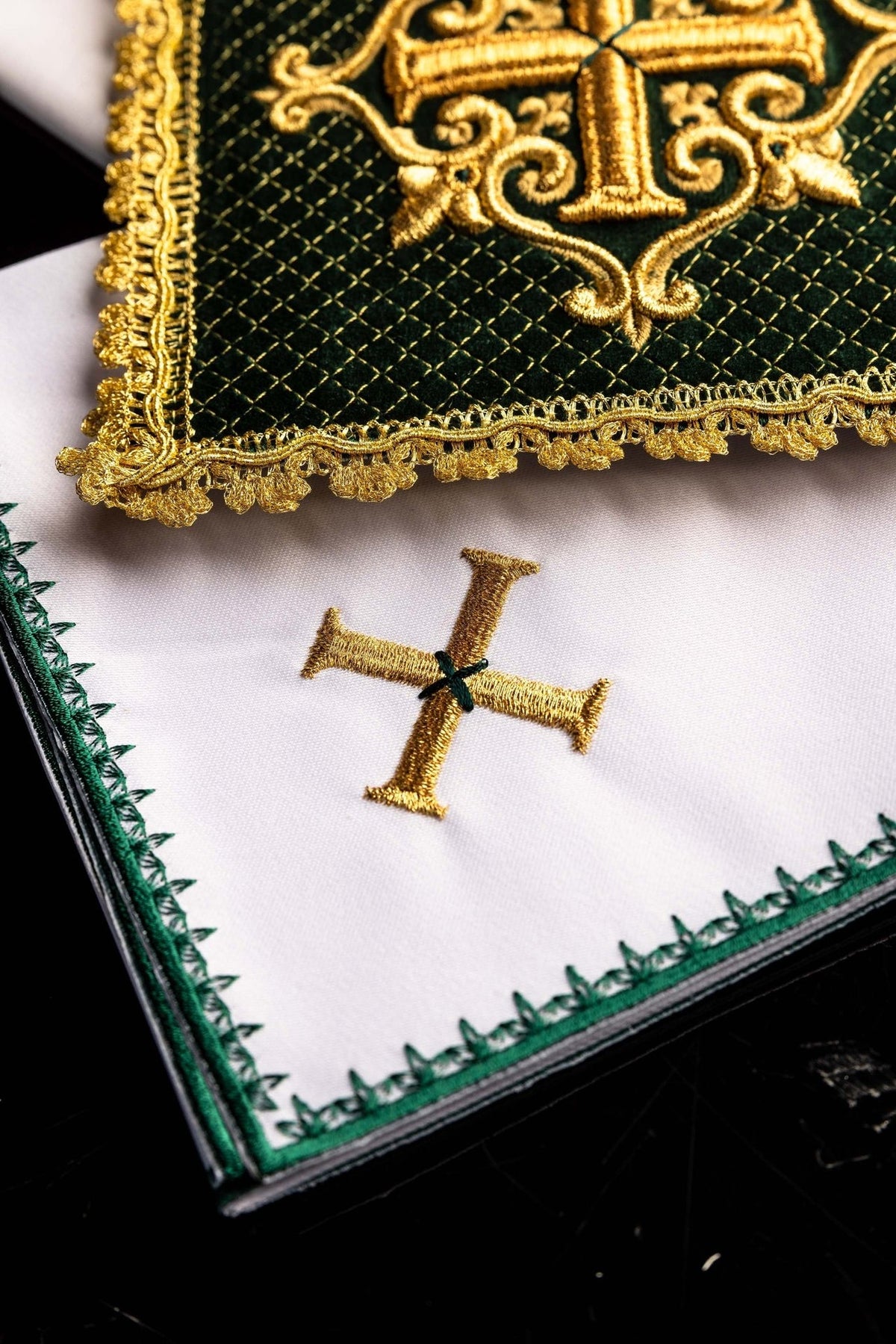 Green velvet chalice pall close-up showing gold cross embroidery, diamond pattern and decorative trim