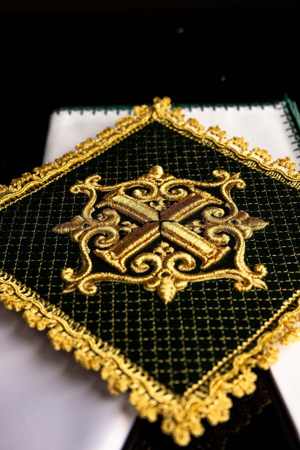 Altar linen set close-up showing white linen with gold embroidered cross and green edging