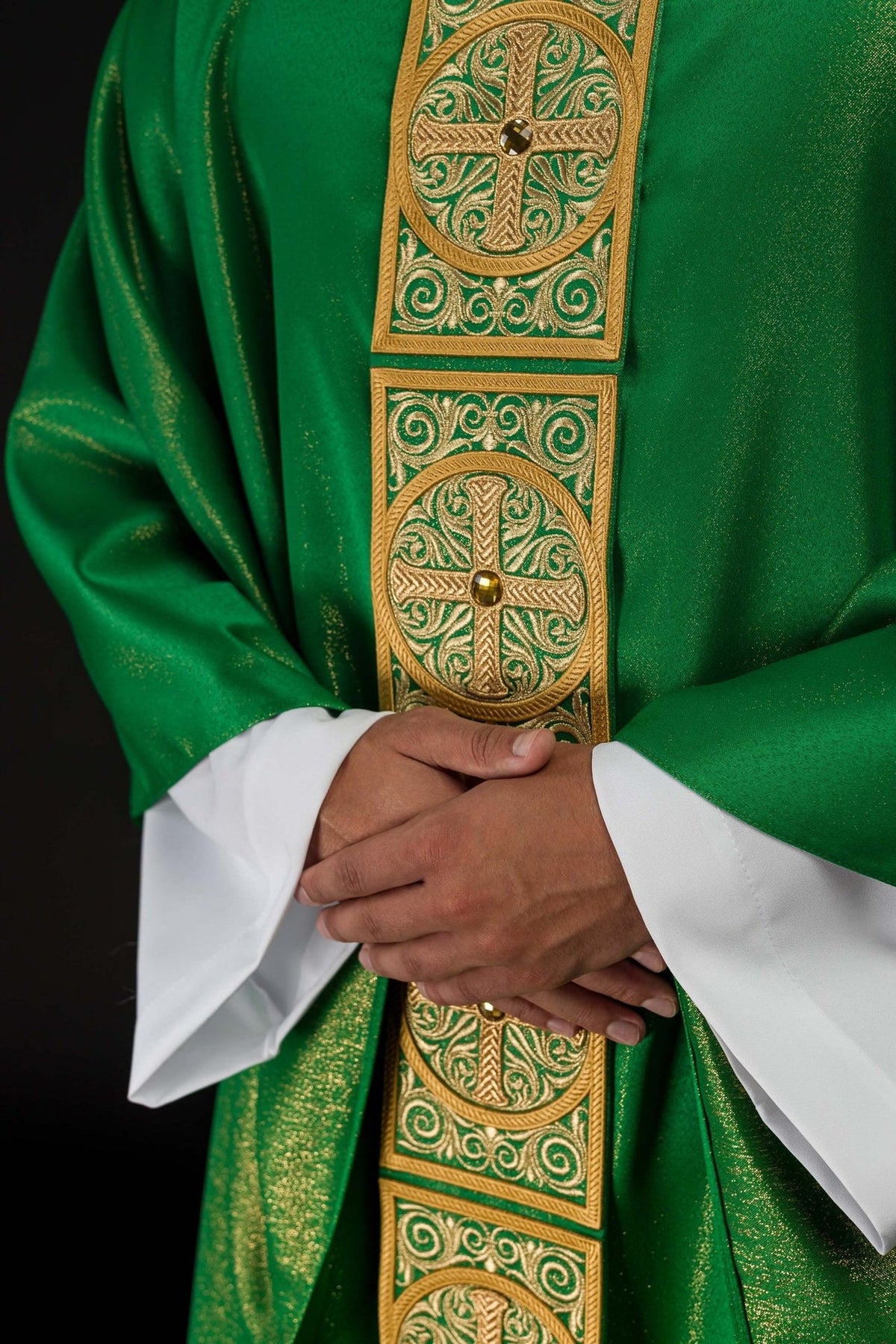 Green chasuble close-up of faceted stone and embroidered cross on orphrey