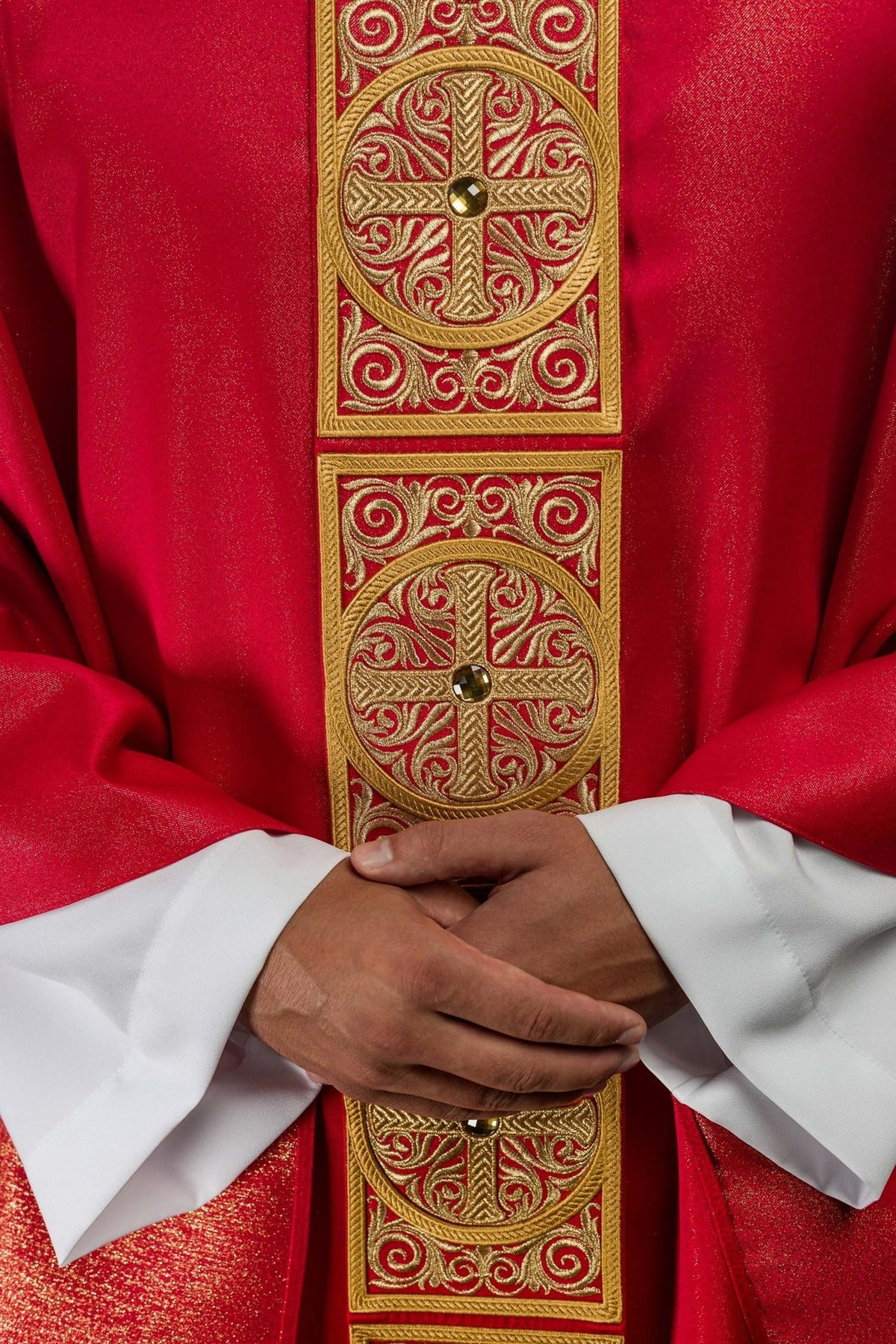 Red chasuble orphrey close-up with embroidered crosses and faceted stones