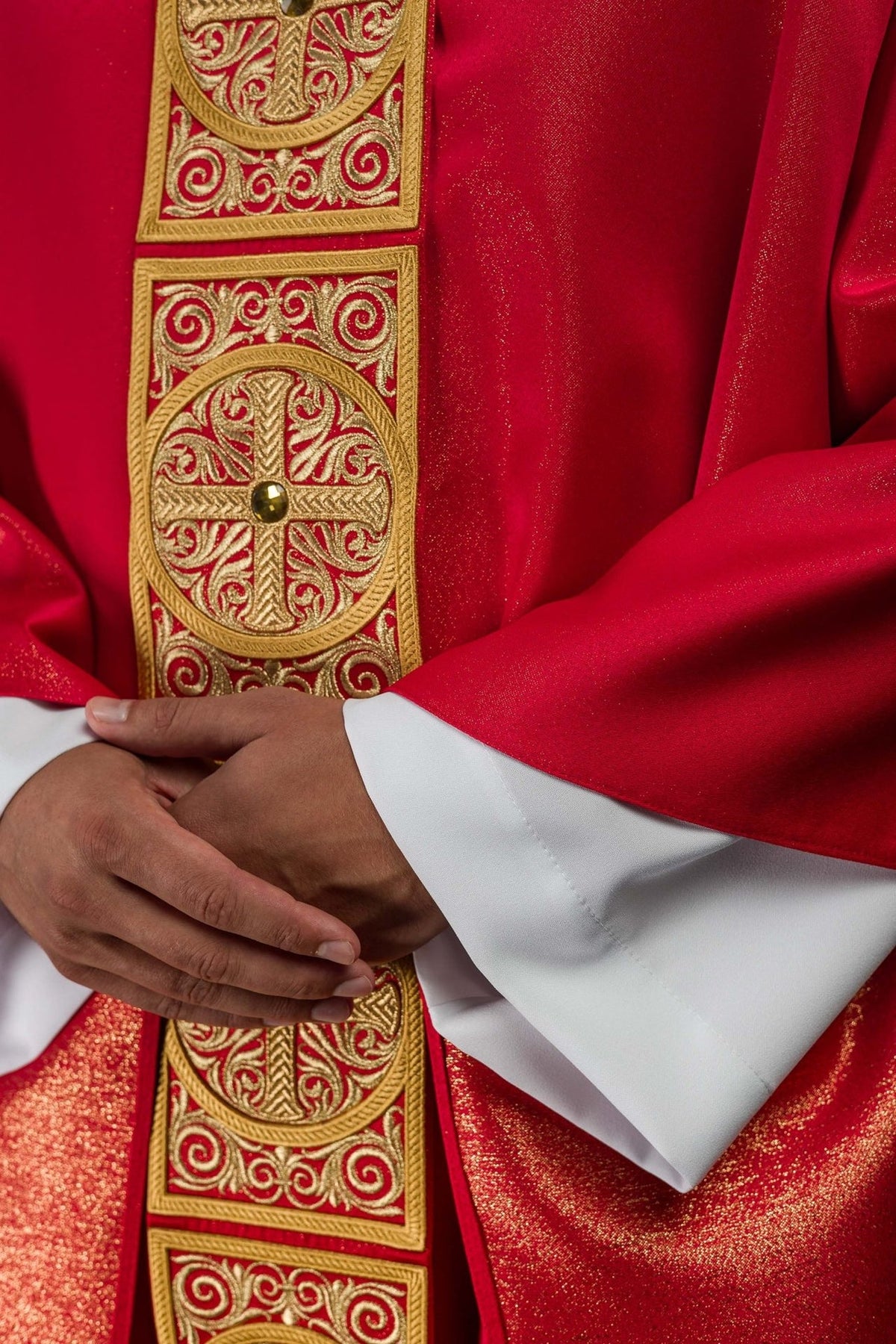 Red chasuble embroidered orphrey detail with gold scrollwork and stones