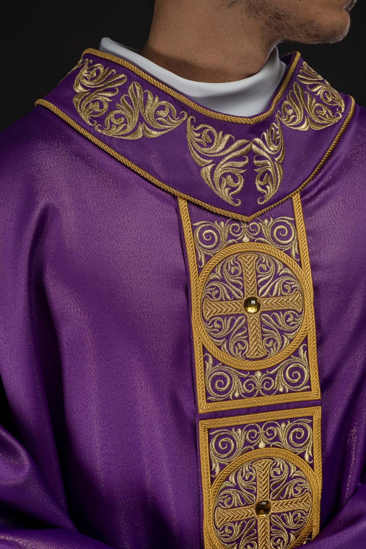 Purple chasuble close-up showing embroidered stand-up collar and faceted stones