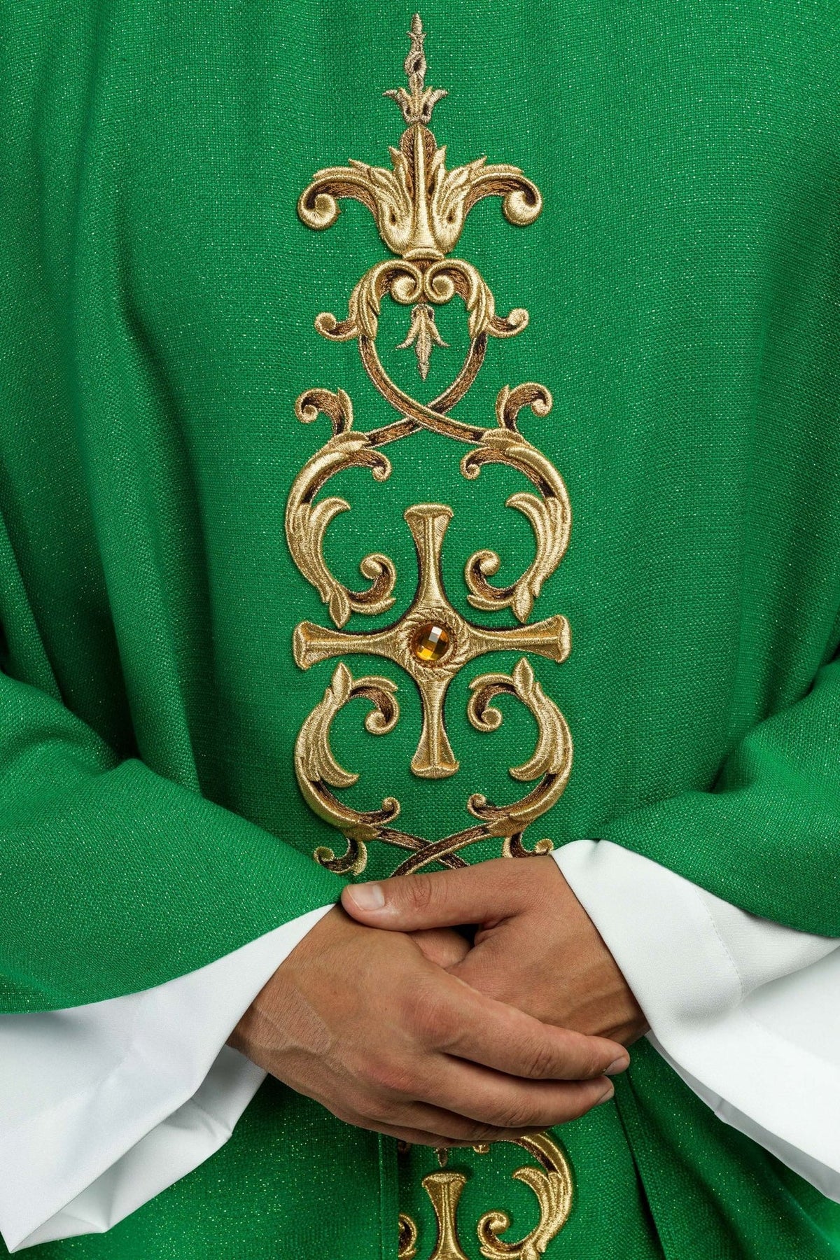 Green chasuble close-up of gold embroidery and central stone