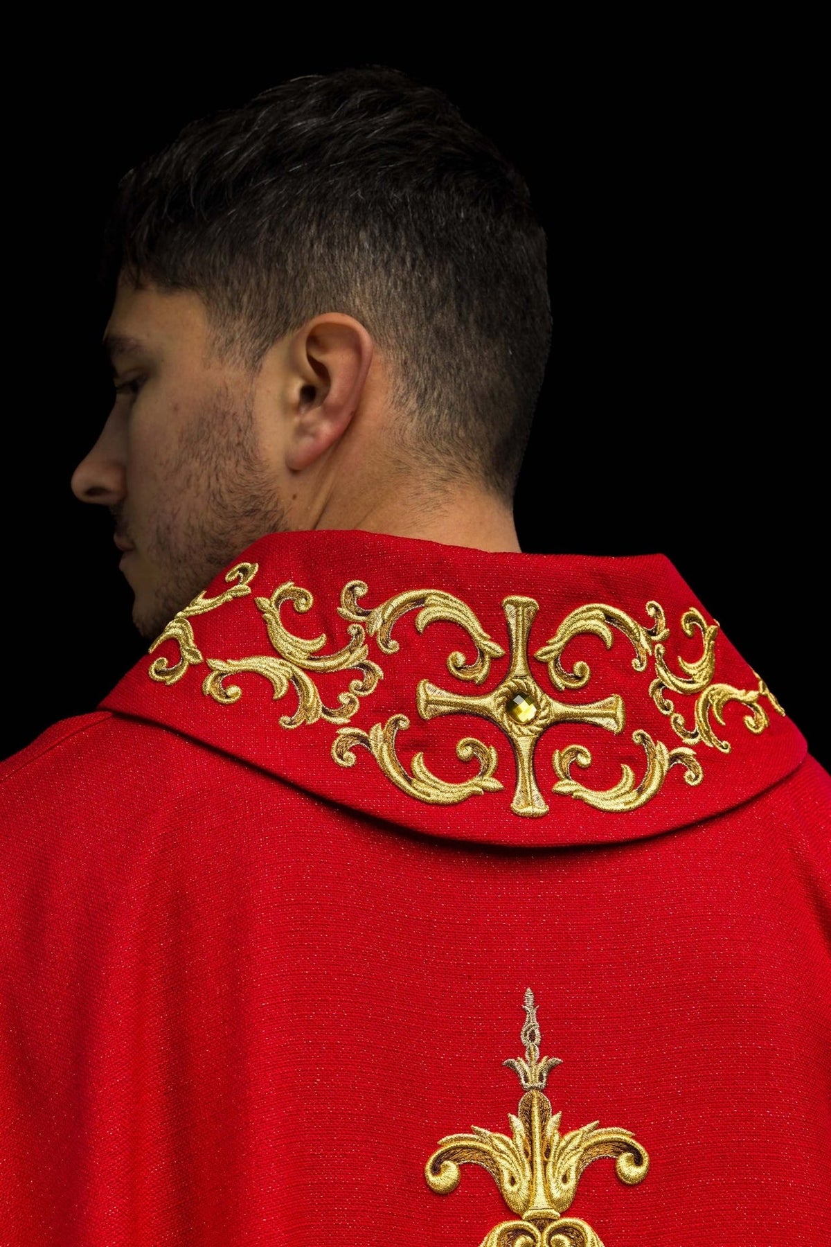 Red chasuble back view with gold embroidered collar and central ornament