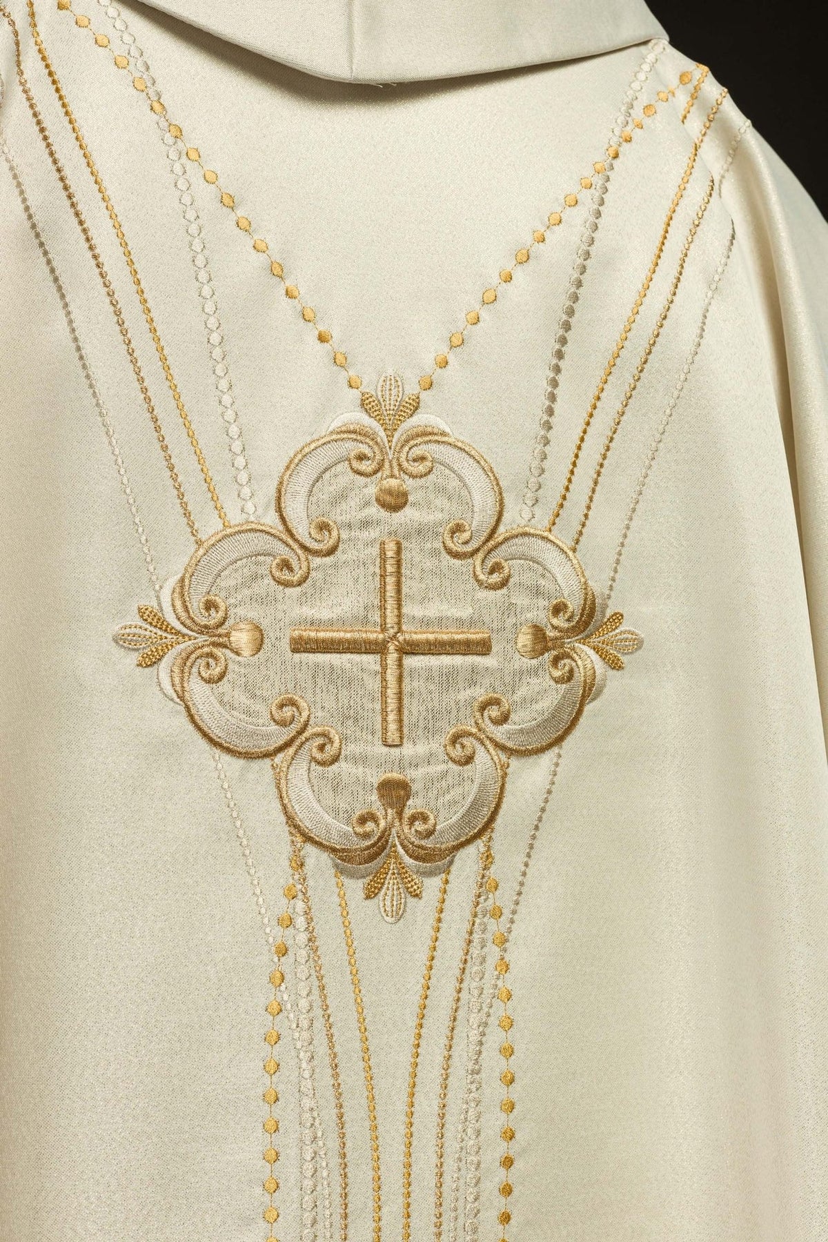 Ecru chasuble close-up of gold cross embroidery and decorative scrollwork