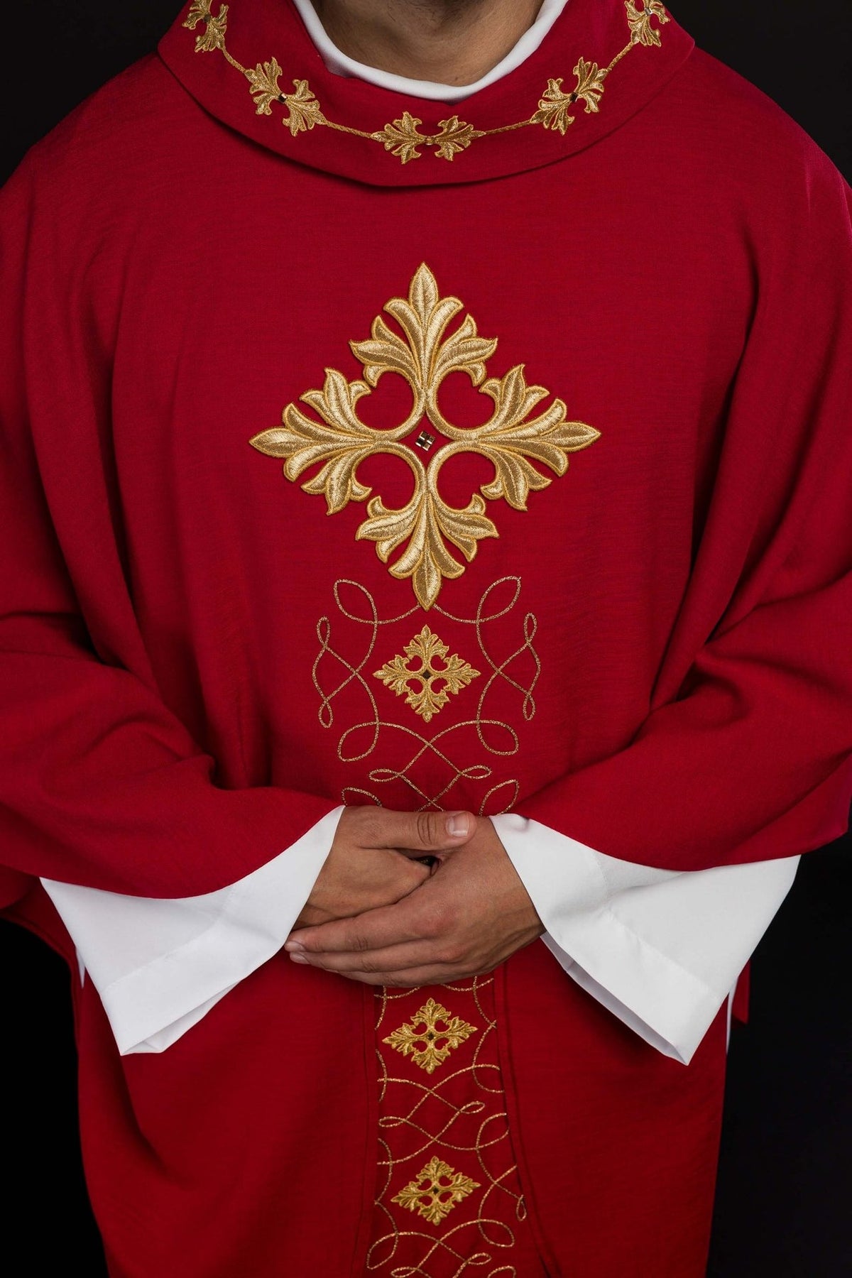 Red chasuble, close-up front view of embroidered cross and gold cord motifs