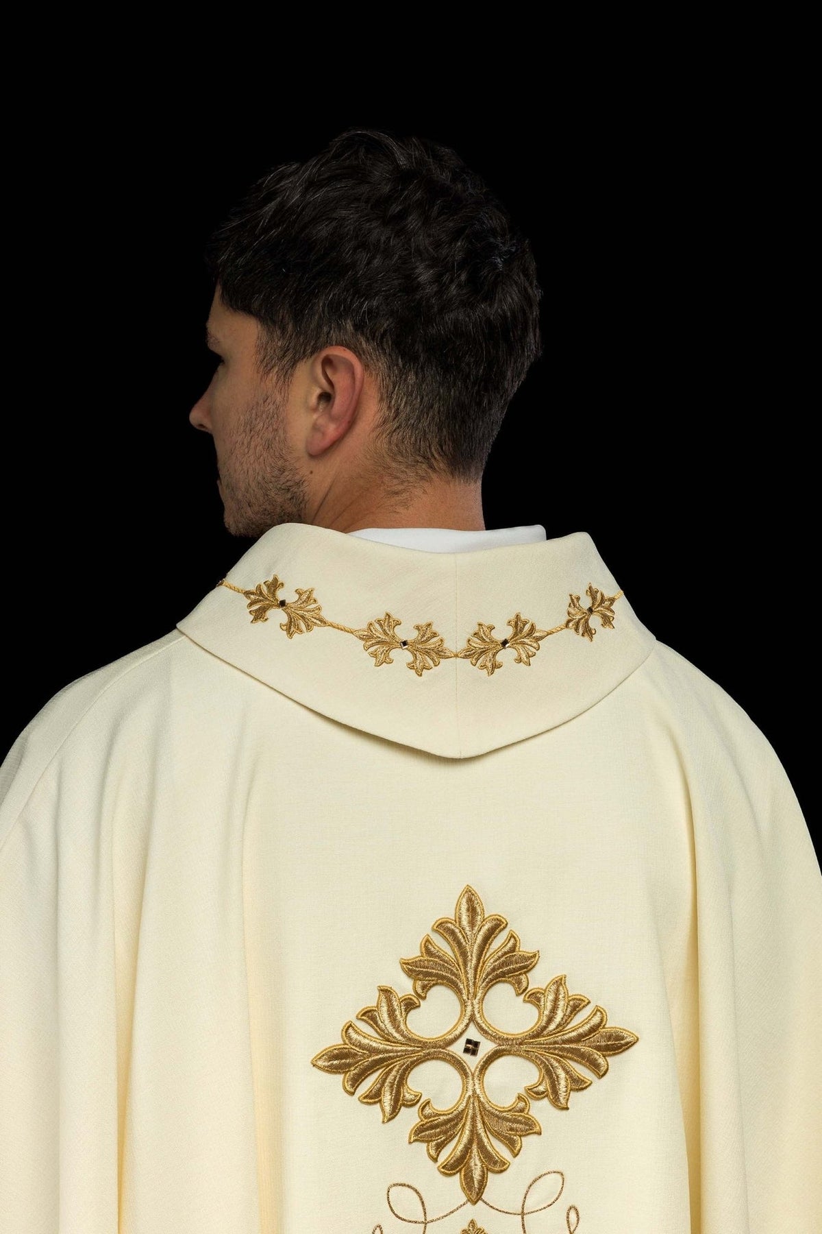Ivory chasuble back view with gold embroidered cross and decorated stand-up collar