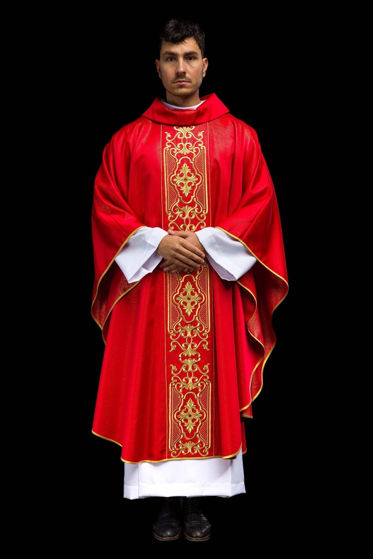 Red chasuble worn front, with gold embroidered central panel and trim