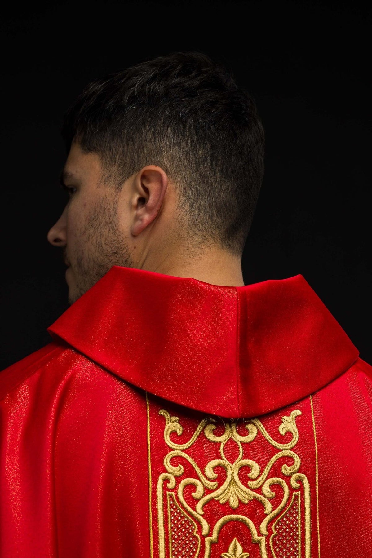 Red chasuble back close-up with gold embroidered panel and stand-up collar