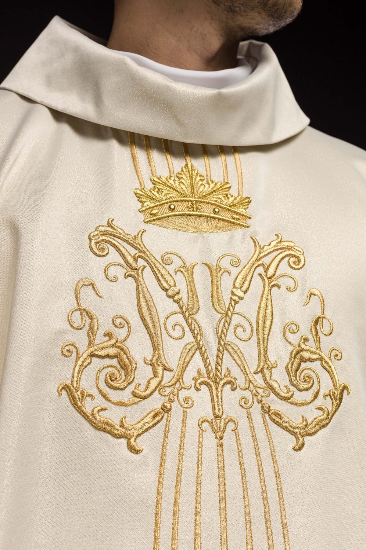 Ecru chasuble close-up showing stand-up collar, crown and gold Marian embroidery