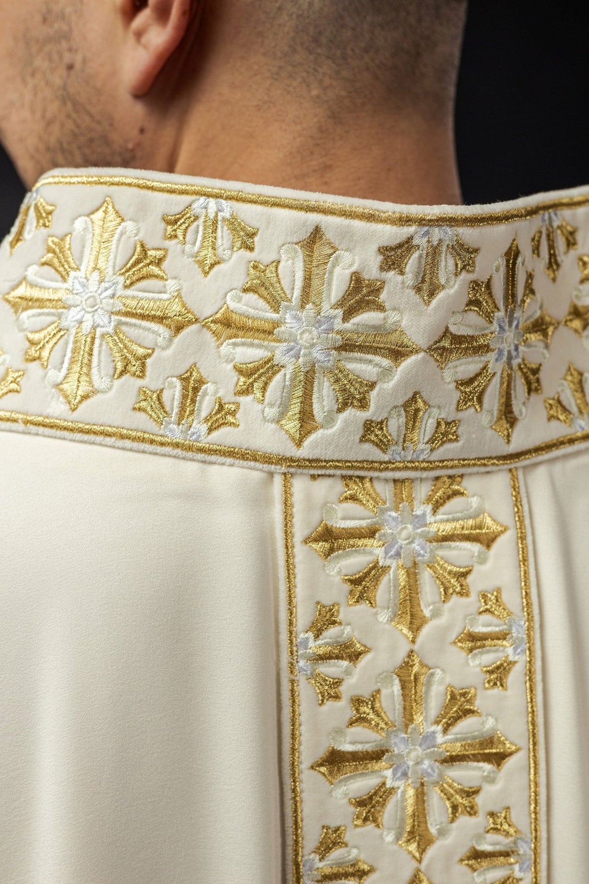 Ecru chasuble close-up of gold and white floral embroidery on the stand-up collar