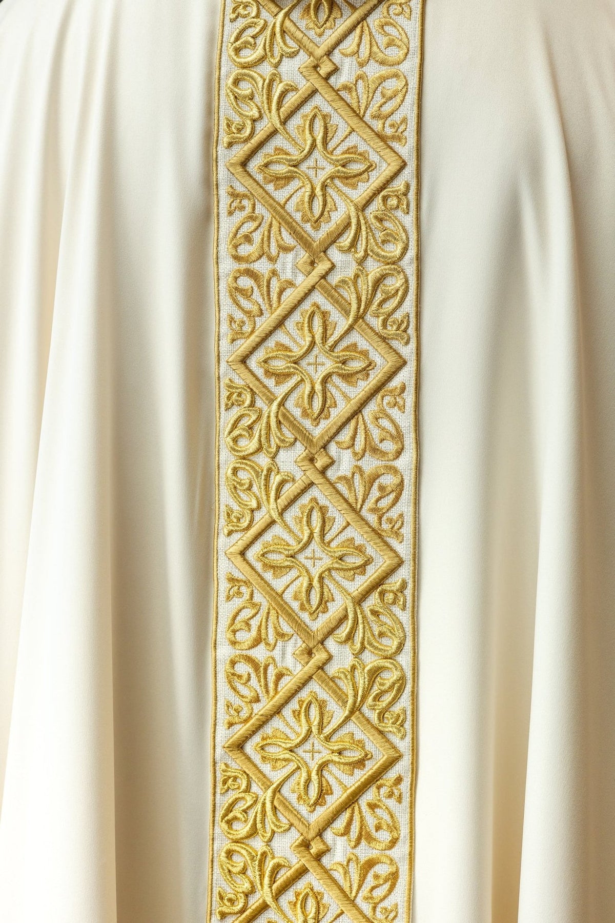 Ecru chasuble close-up of gold floral embroidery and cross motifs