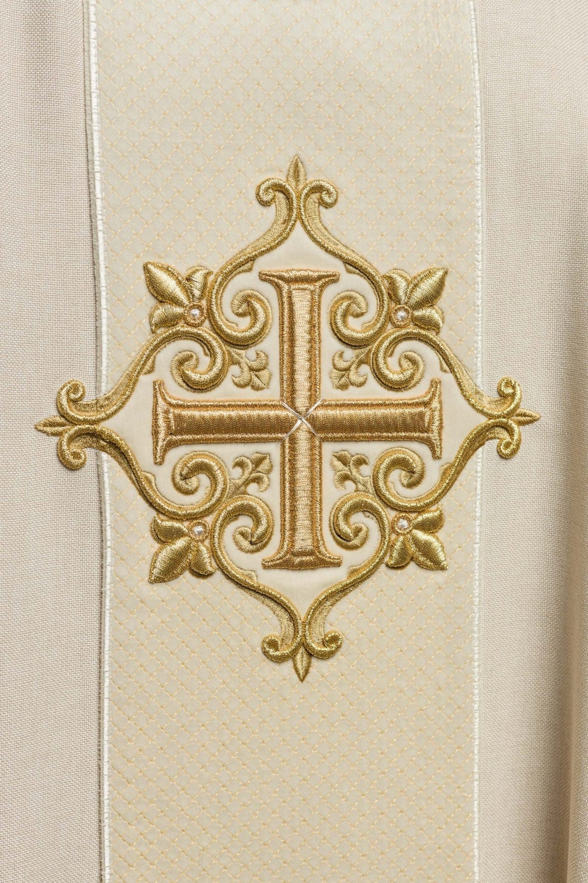 Ecru chasuble close-up of ornate gold cross embroidery on the front panel