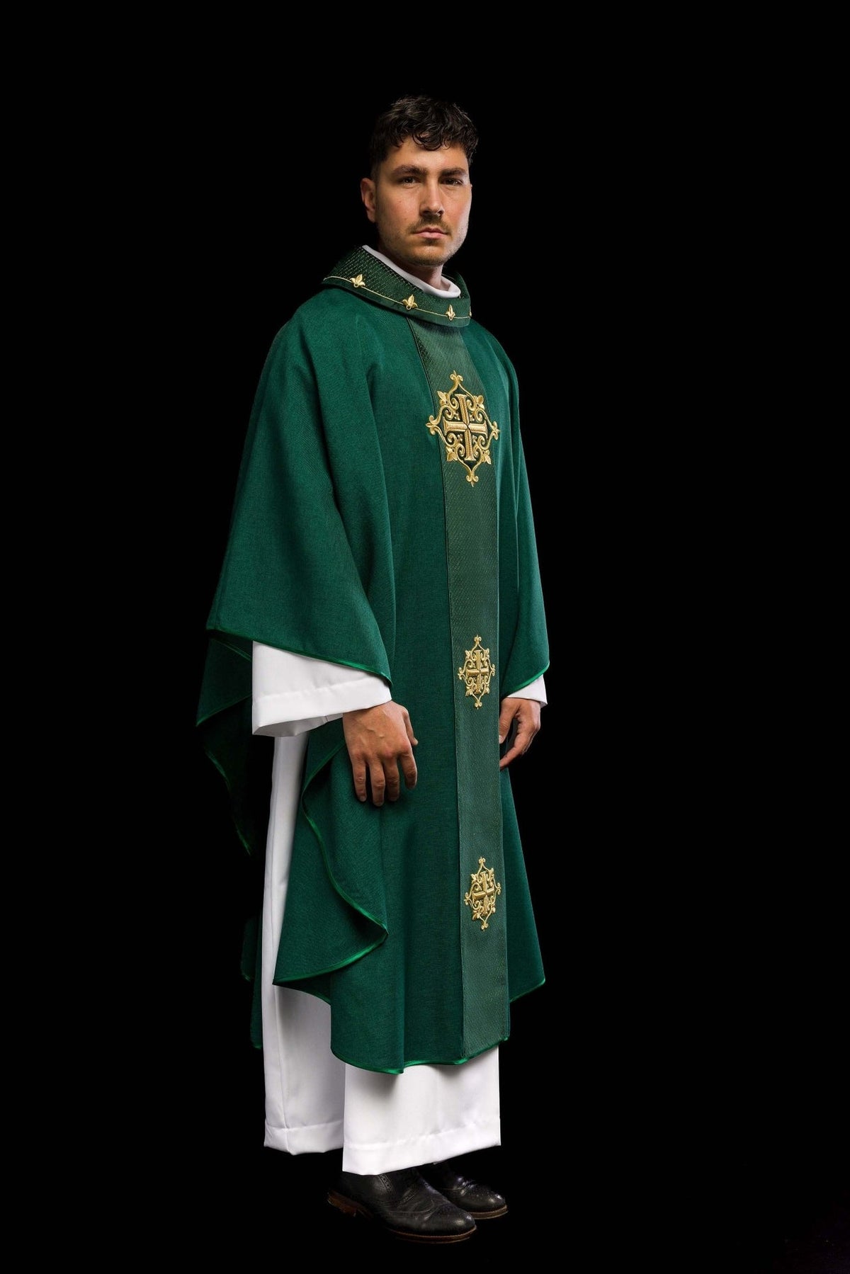 Green chasuble side view showing velvet orphrey and gold cross embroidery