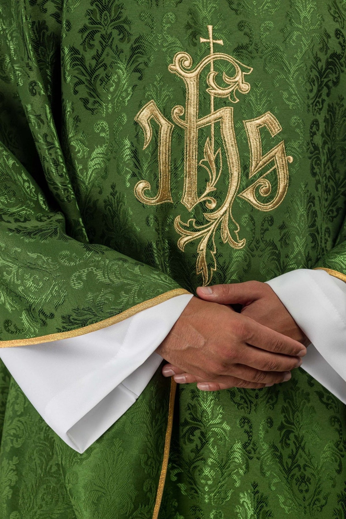 Green chasuble close-up showing gold trim and decorative fabric