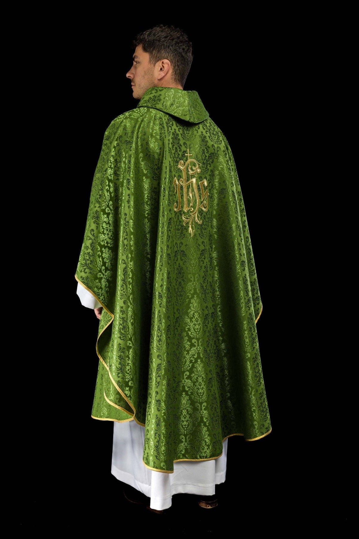 Green chasuble side-back view with gold trim and embroidered IHS motif