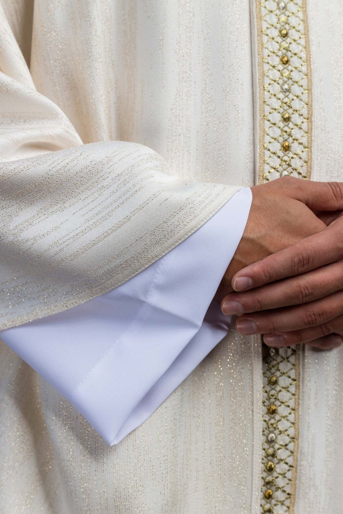 White chasuble fabric and embroidered orphrey close-up