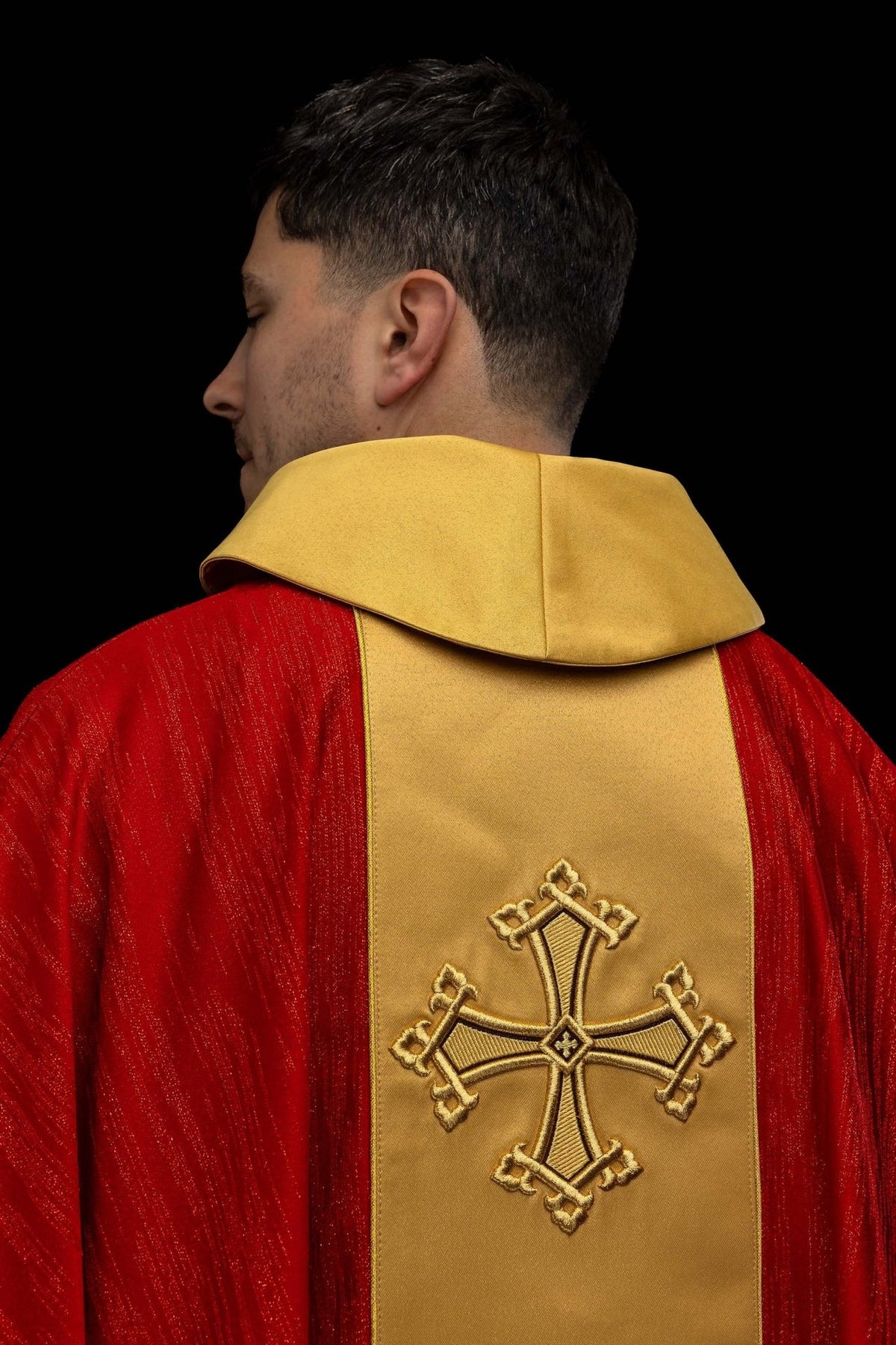 Red chasuble back view with gold orphrey and cross embroidery