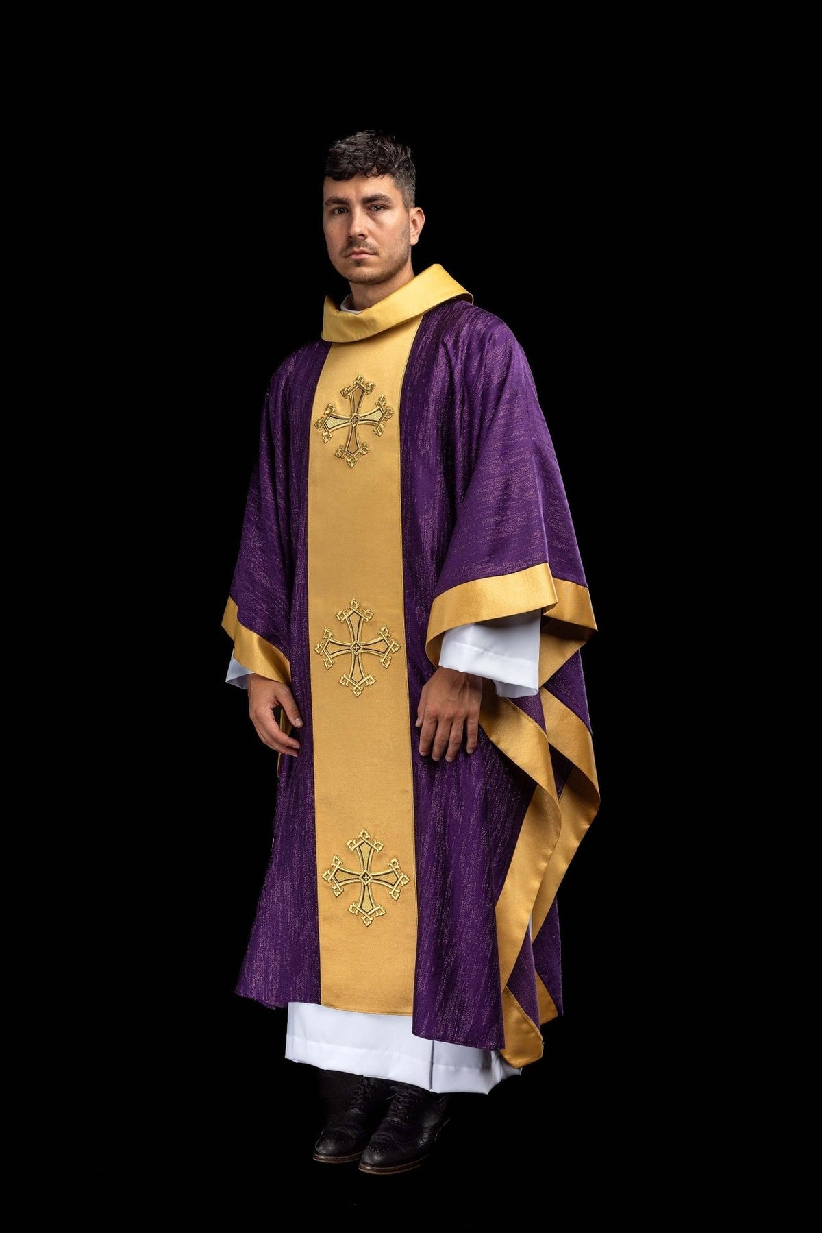 Purple chasuble worn, full front view with gold orphrey and embroidered crosses