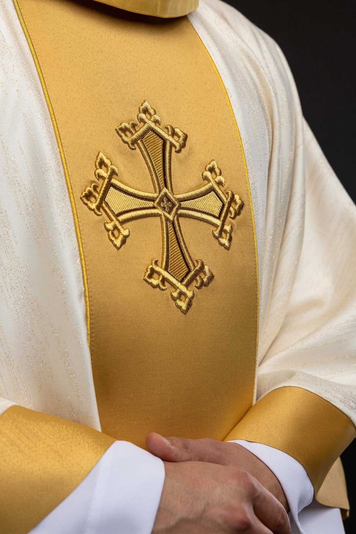 Ecru chasuble close-up of embroidered gold cross and orphrey trim
