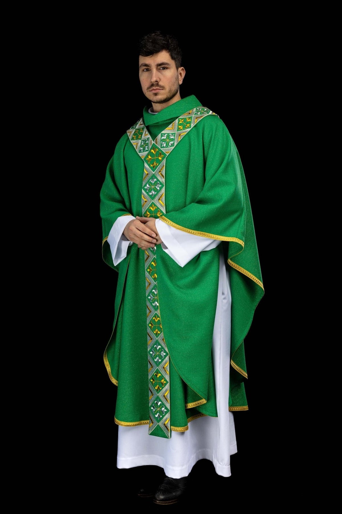 Green chasuble worn at an angle, showing the front embroidered orphrey and gold trim