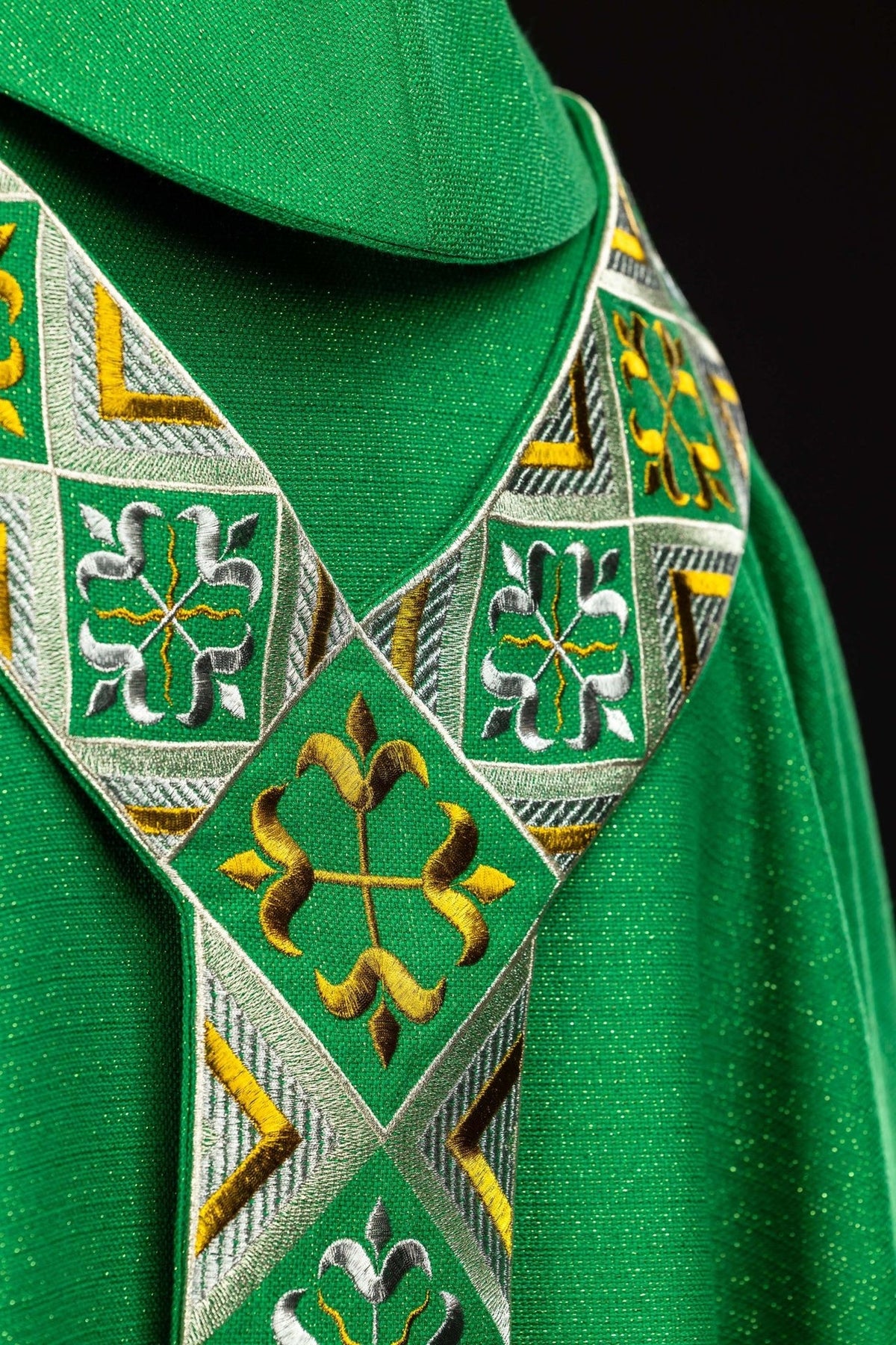 Green chasuble orphrey close-up with gold and silver embroidery at the shoulder