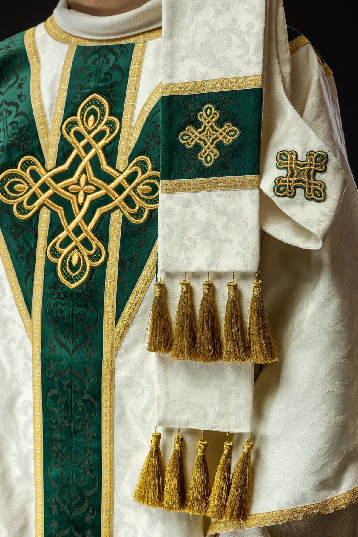 Chasuble sleeve detail with white jacquard fabric and gold decorative trim