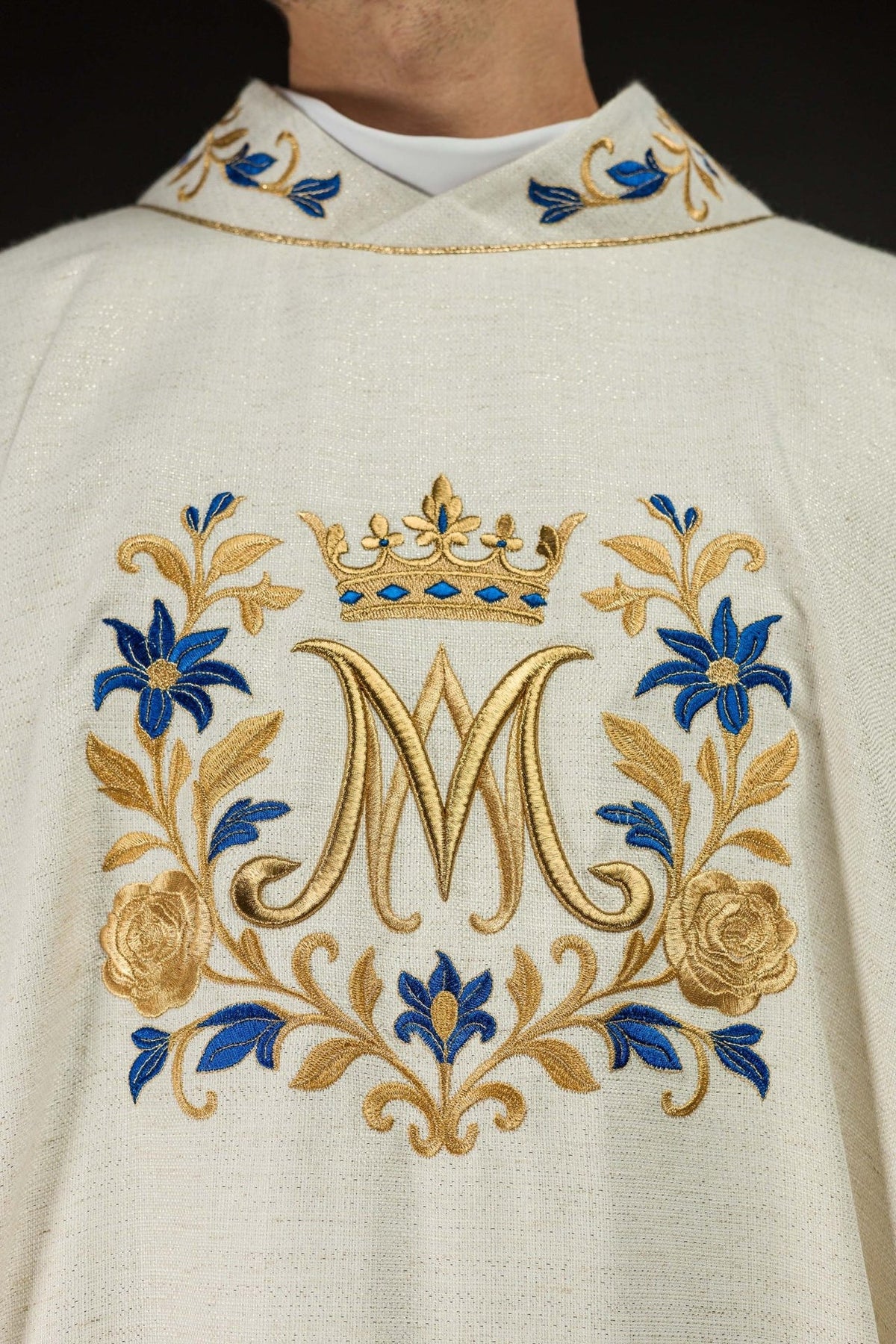 Ecru chasuble close-up showing embroidered Marian motif and stand-up collar