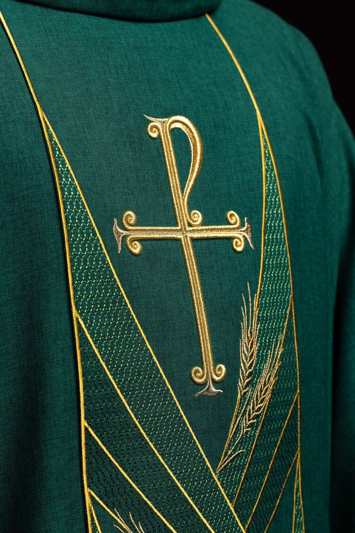 Green chasuble close-up showing embroidered gold cross, wheat and patterned orphrey