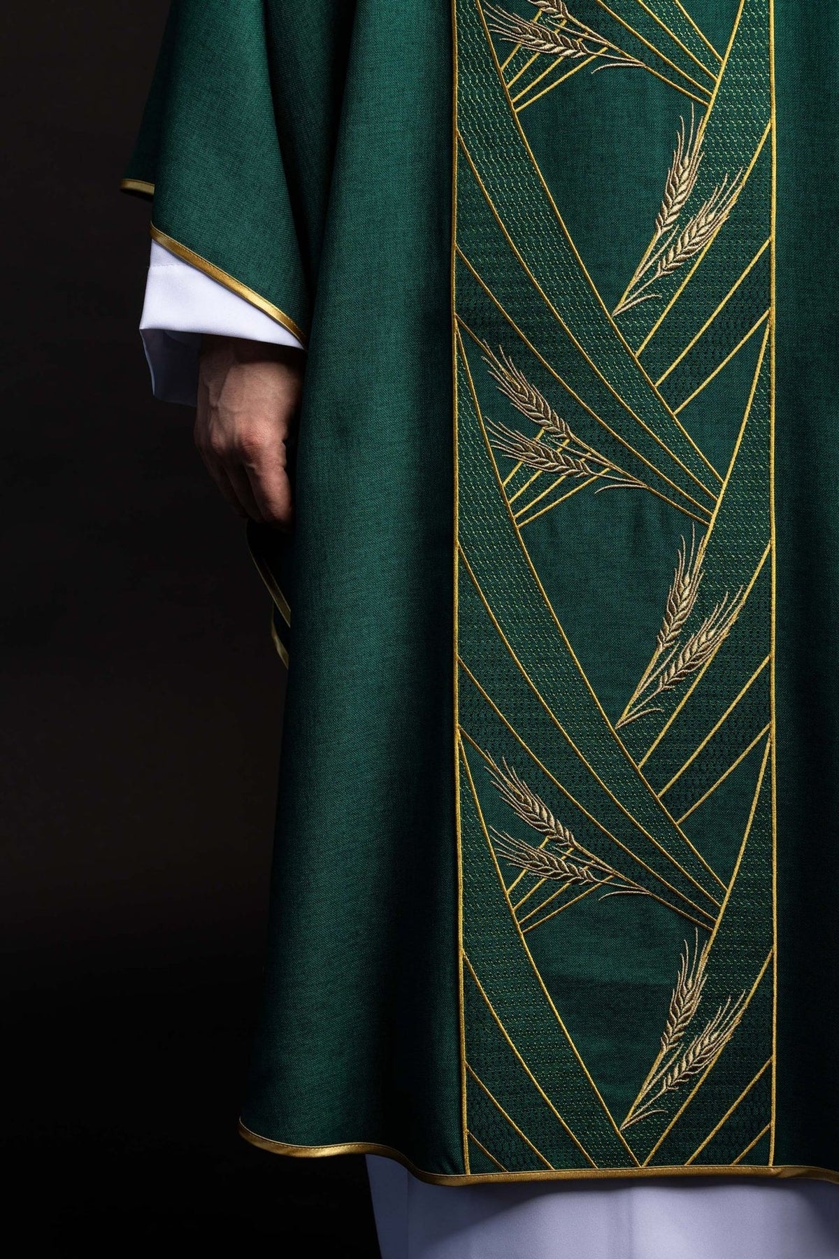 Green chasuble detail showing wheat embroidery on the gold-trimmed orphrey