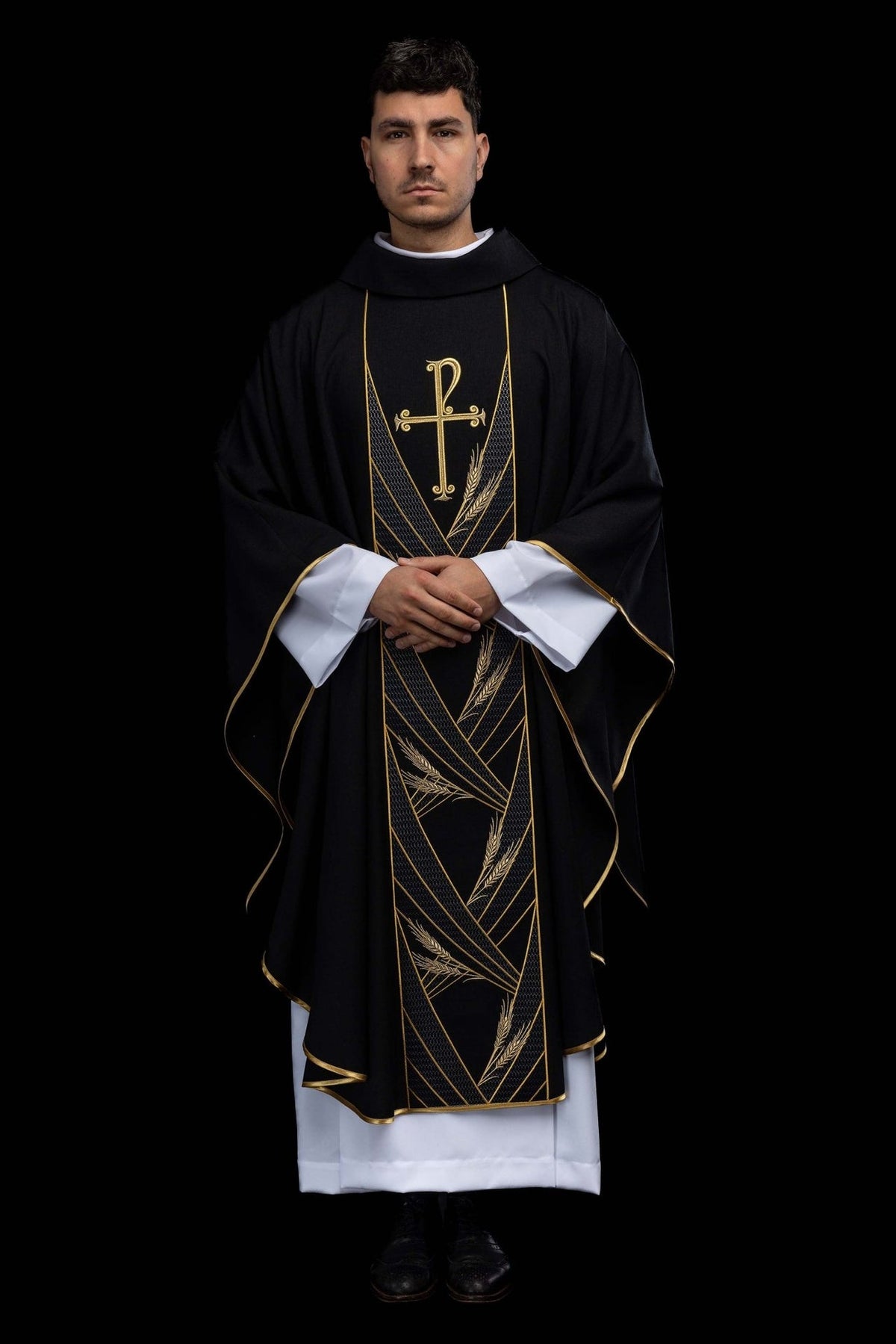 Black chasuble full front view with gold orphrey, cross and wheat embroidery