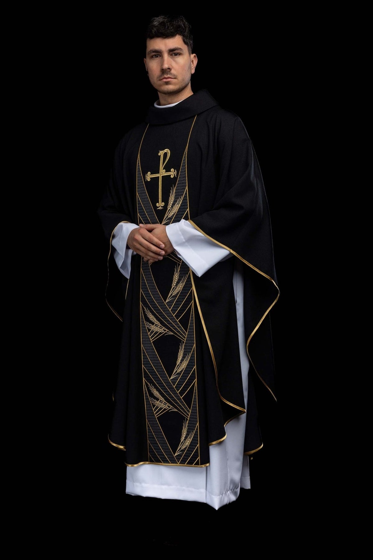 Black chasuble angled front view with gold PAX embroidery, wheat motifs and trim