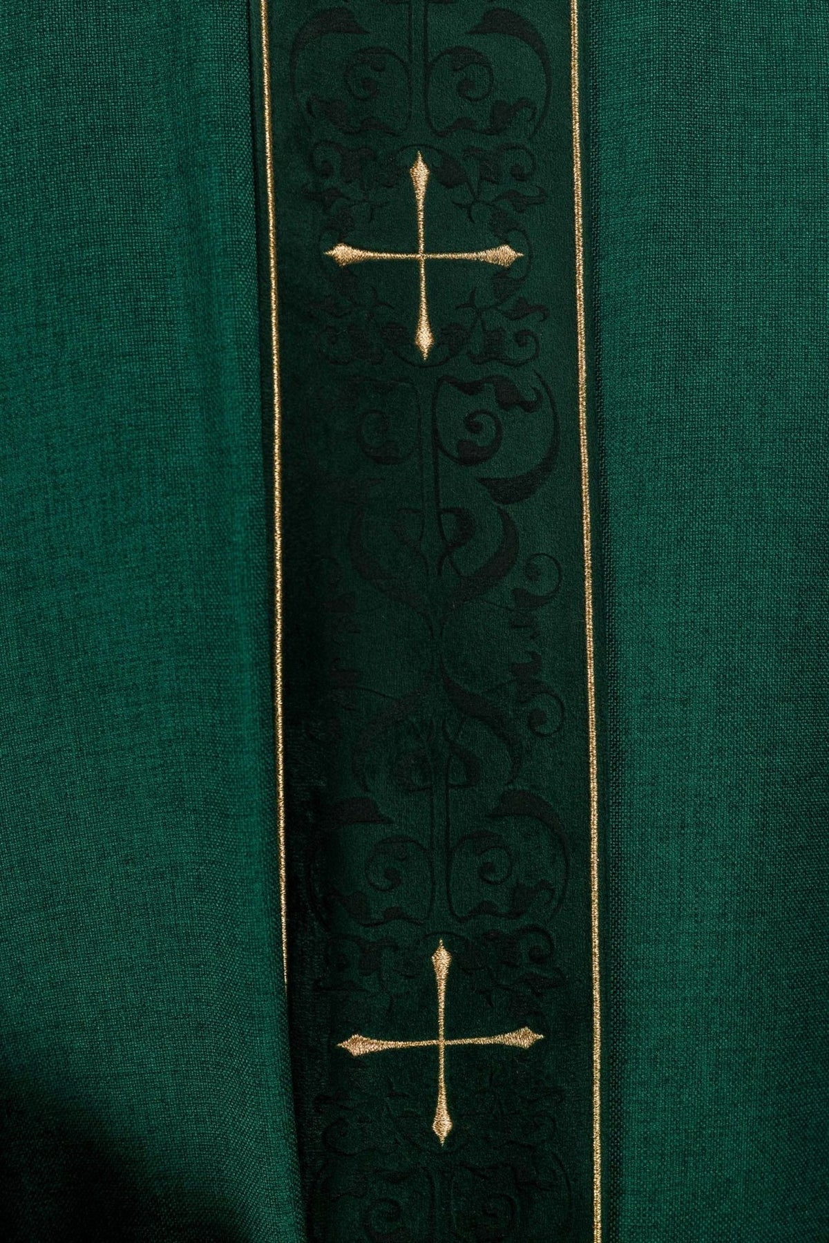Green chasuble close-up of gold cross embroidery on the orphrey
