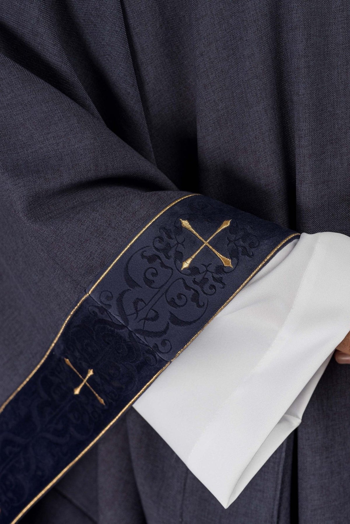 Purple chasuble close-up of embroidered cuff with gold cross and gold edging