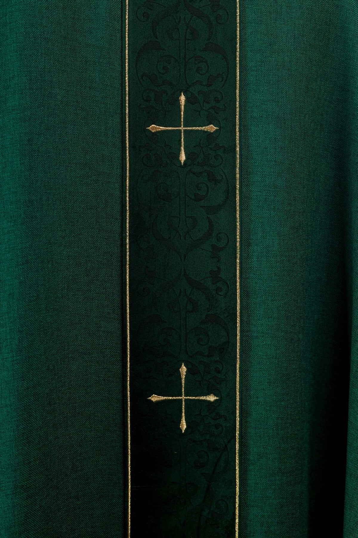 Green chasuble orphrey close-up with two gold crosses and dark embroidery