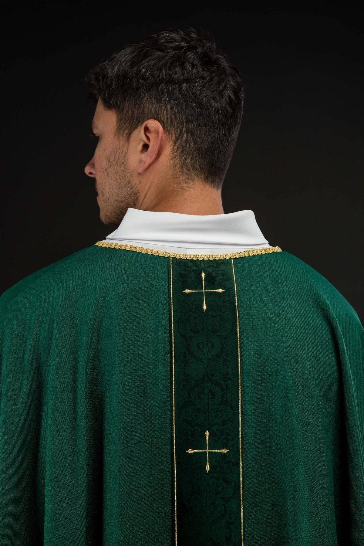Green chasuble back view with embroidered orphrey and multiple gold crosses