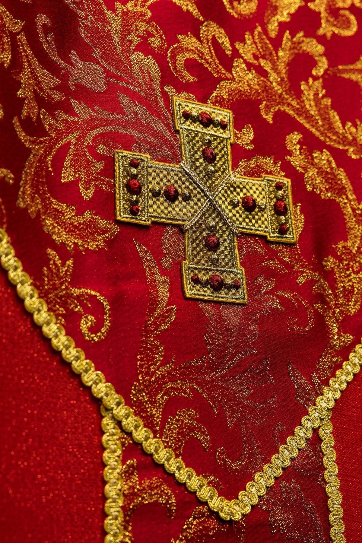 Red chasuble sleeve detail with gold edging and red fabric