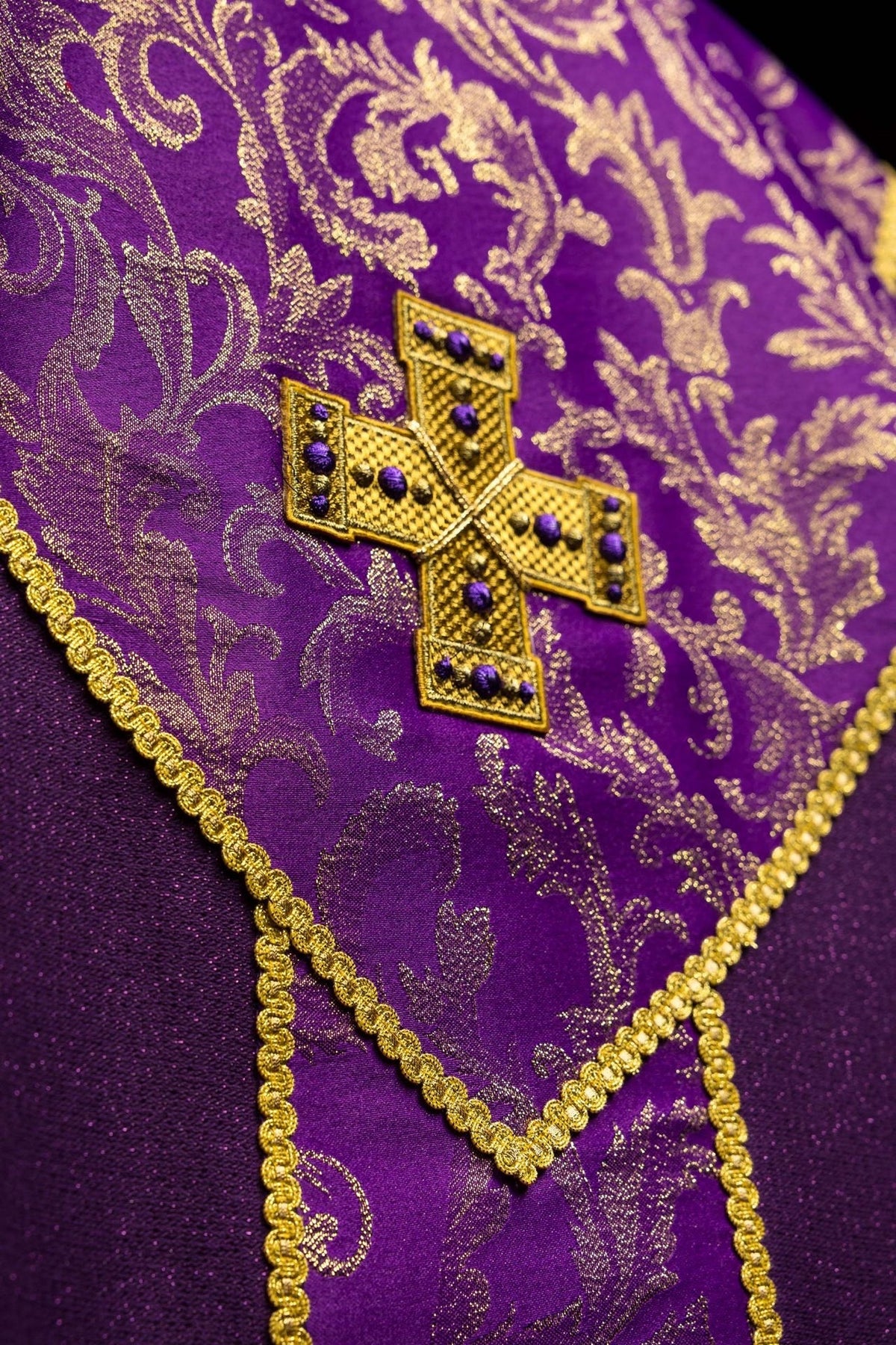 Purple chasuble shoulder detail with gold-edged embroidered orphrey