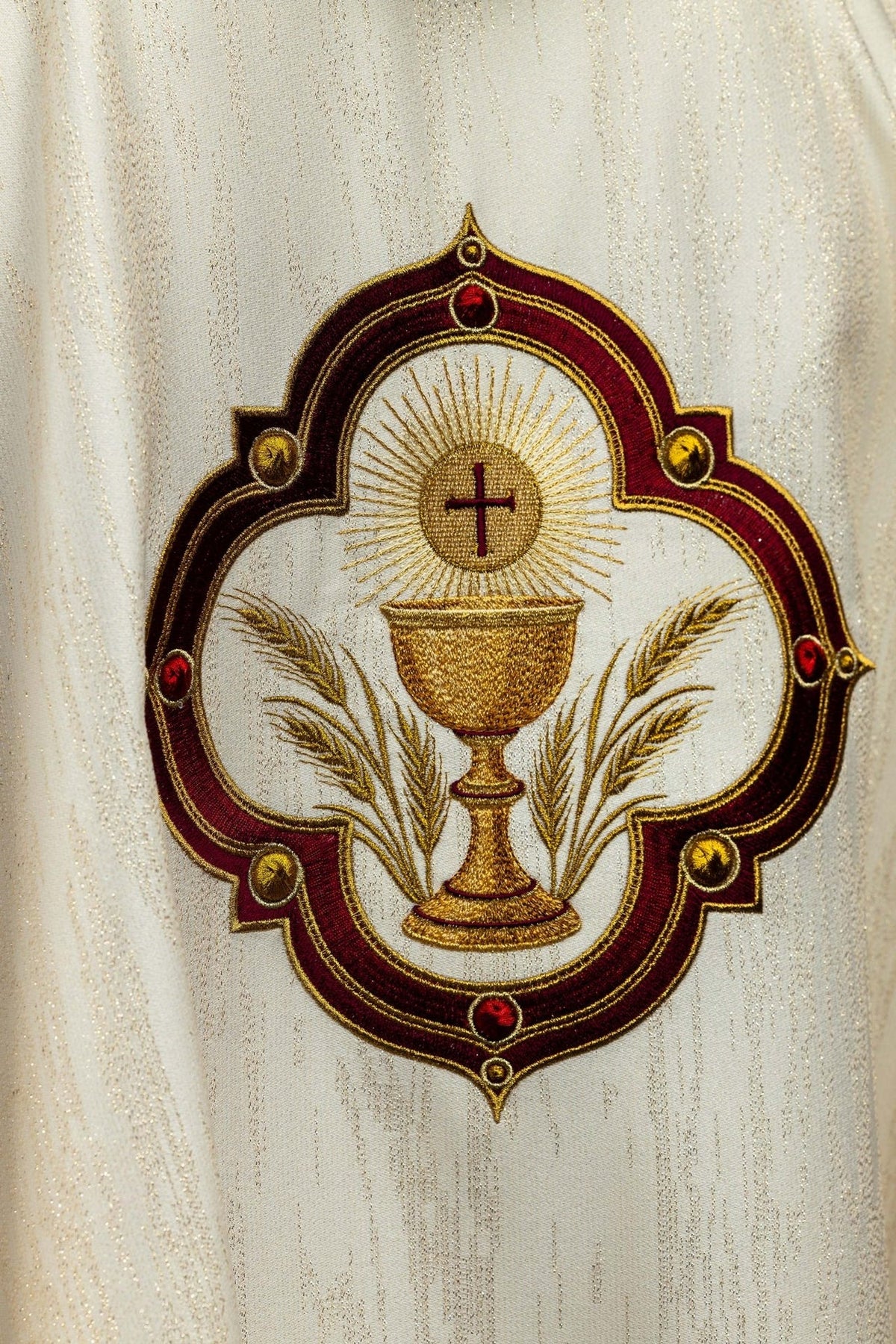 Chasuble back view in cream with gold-trimmed collar and communion chalice embroidery