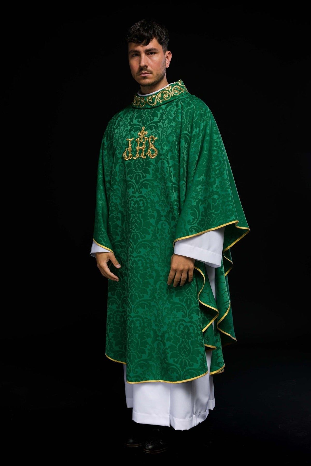 Green chasuble worn in a side view, showing gold trim and patterned satin