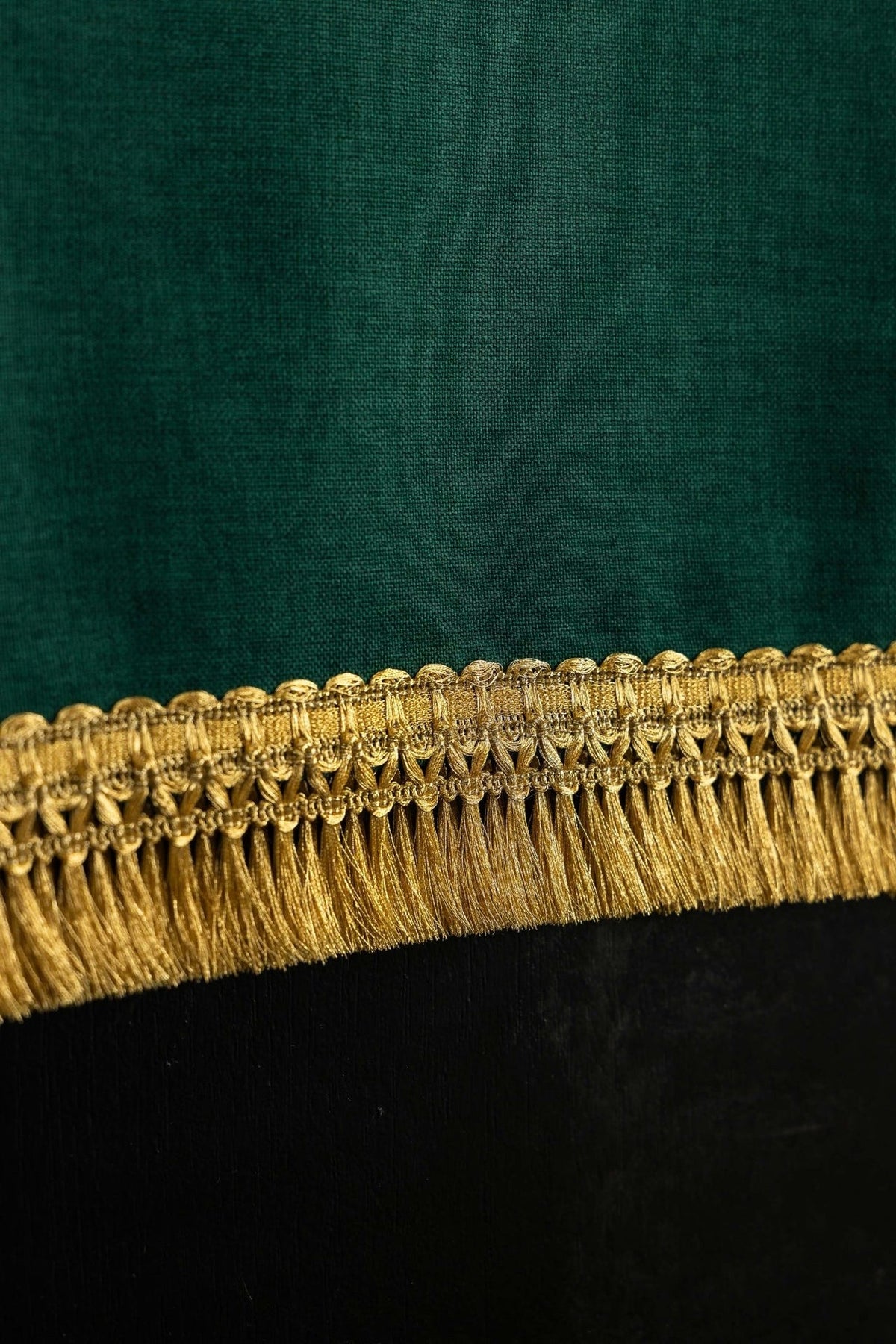 Green church lectern cover close-up showing gold fringe trim