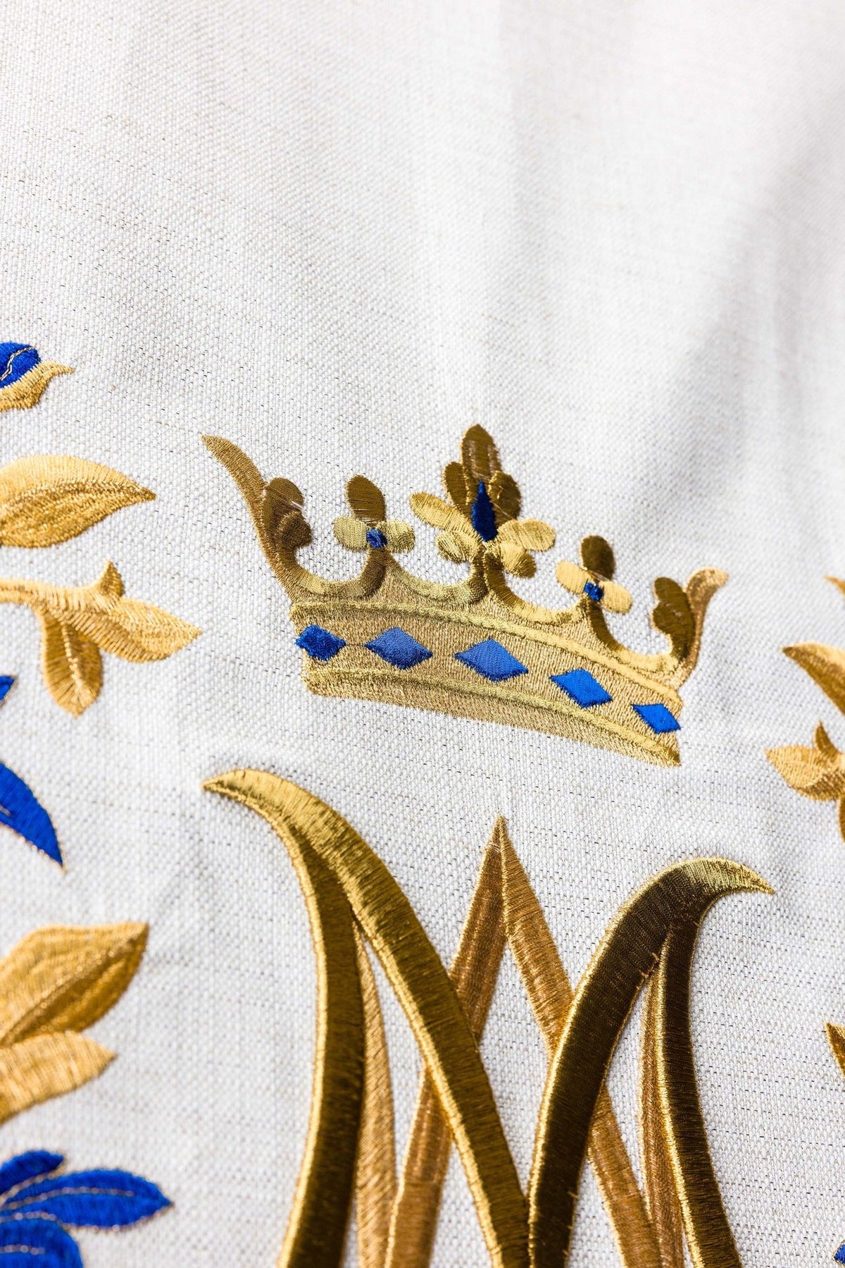 Church lectern cover close-up of embroidered gold crown and Marian motif