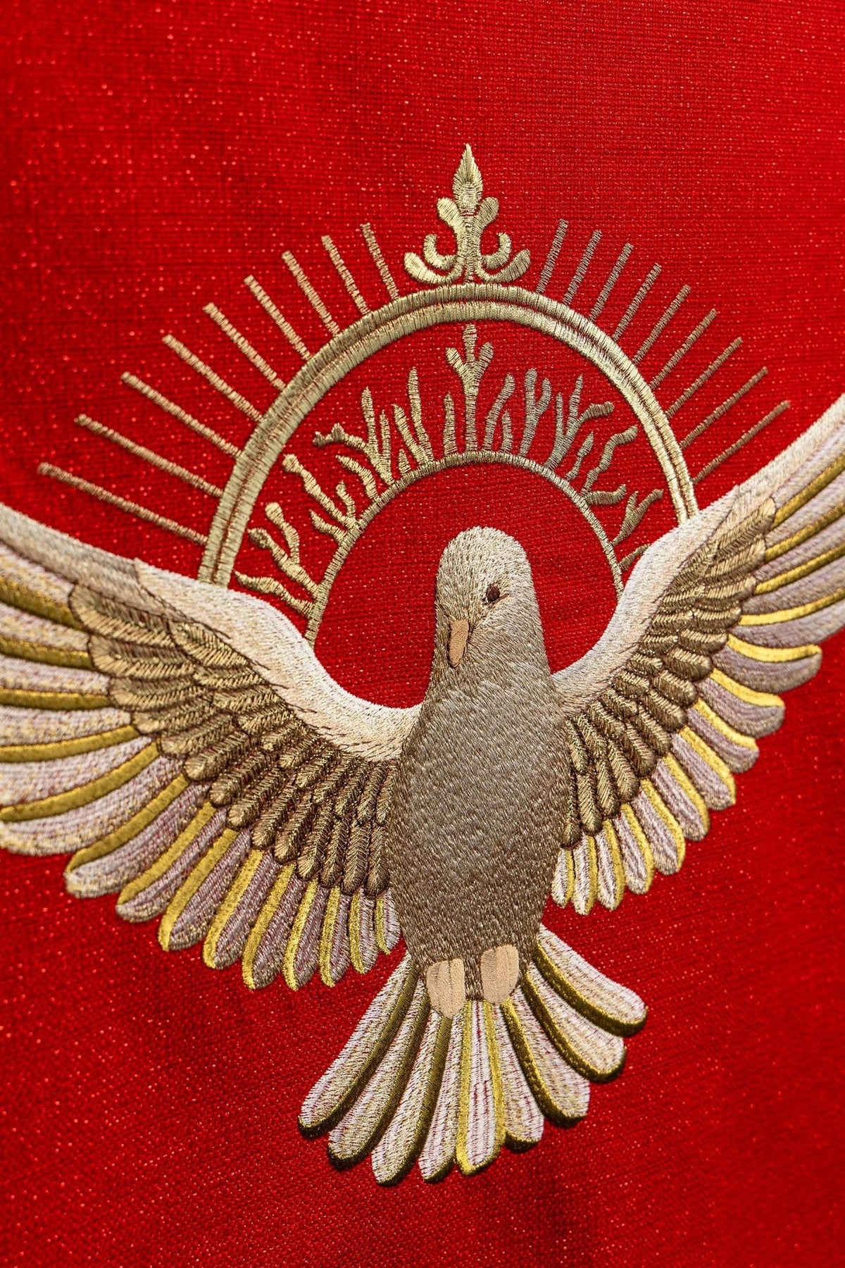 Church lectern cover close-up of embroidered gold Holy Spirit dove with radiant halo