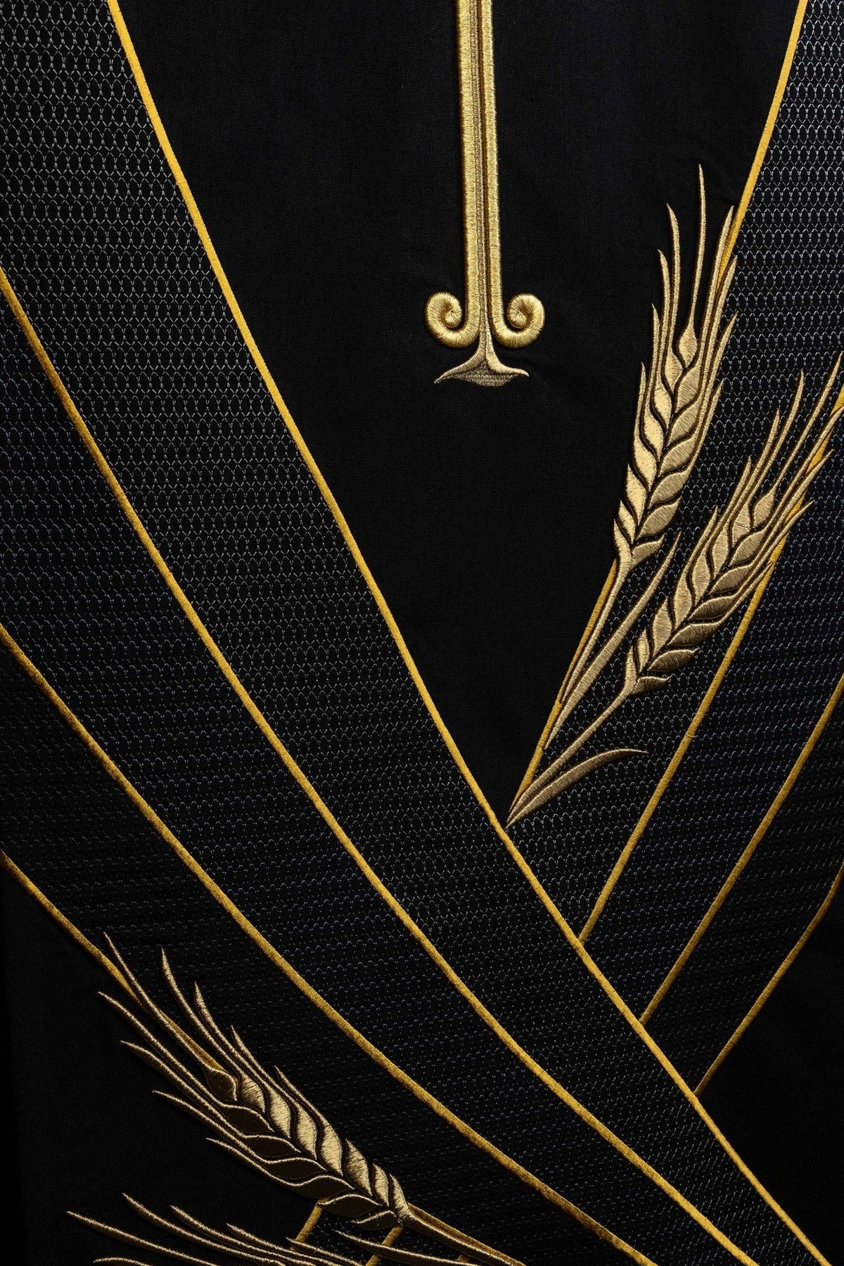Black church lectern cover detail of gold wheat embroidery and diagonal lines