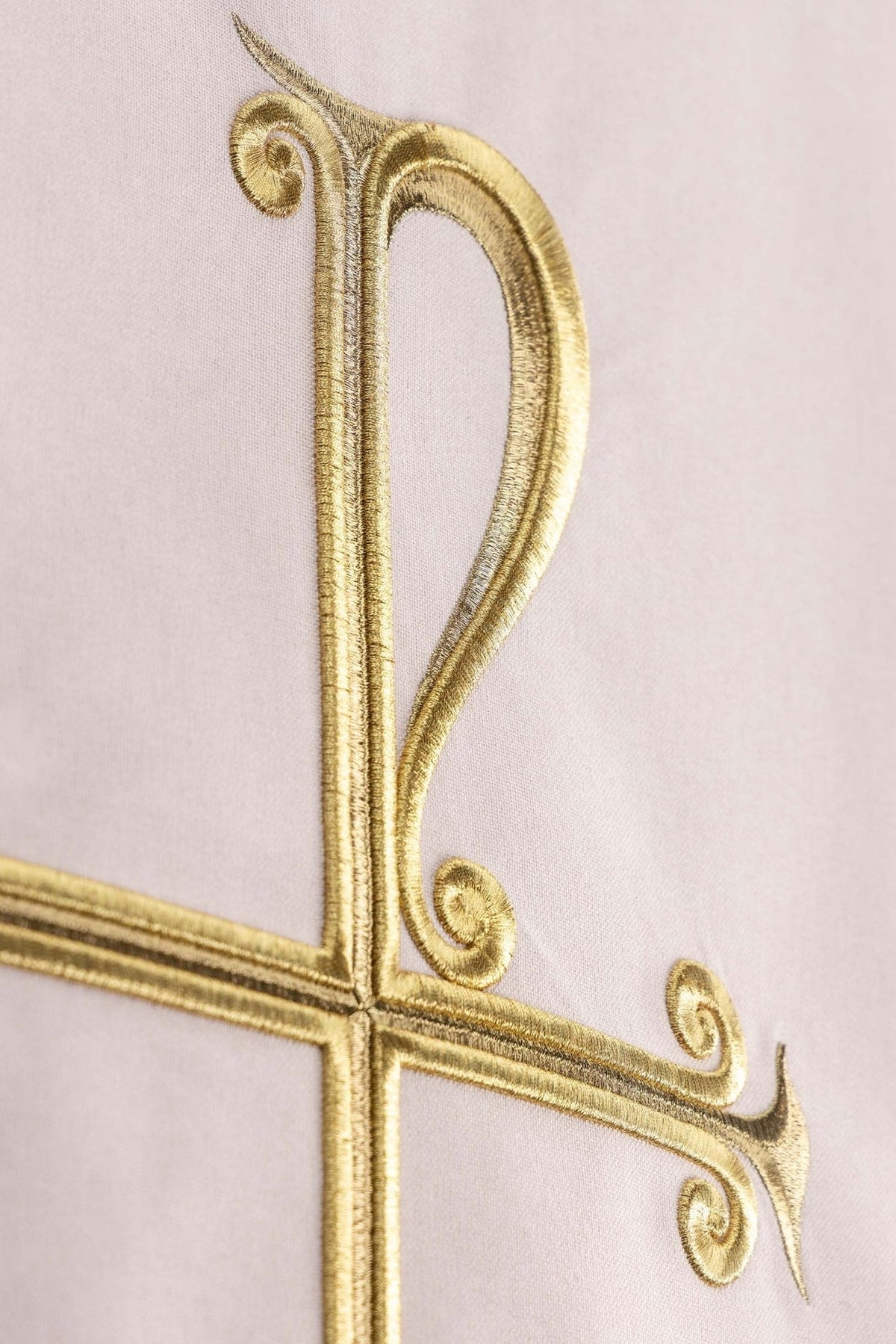 Church lectern cover close-up showing gold PAX cross embroidery on white fabric