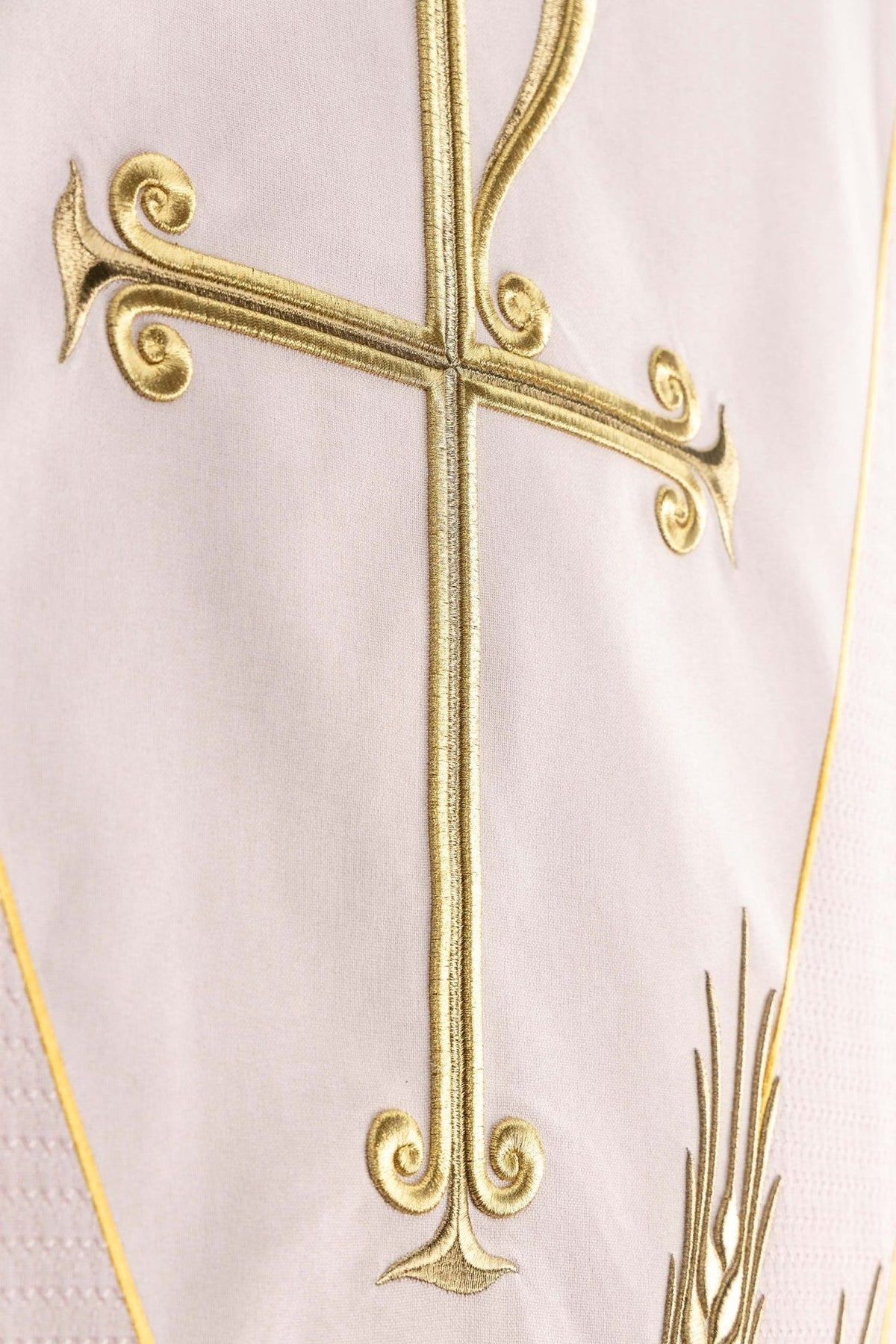 Church lectern cover close-up of gold cross embroidery and decorative scrolls