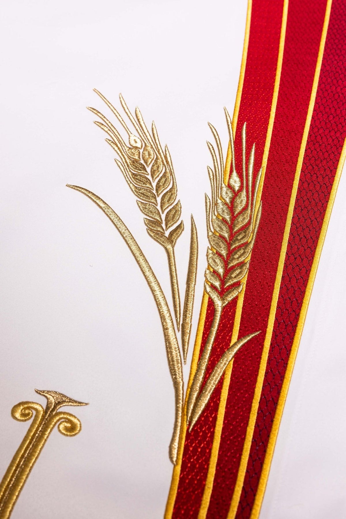 Altar cloth close-up showing gold PAX cross, wheat and red embroidery