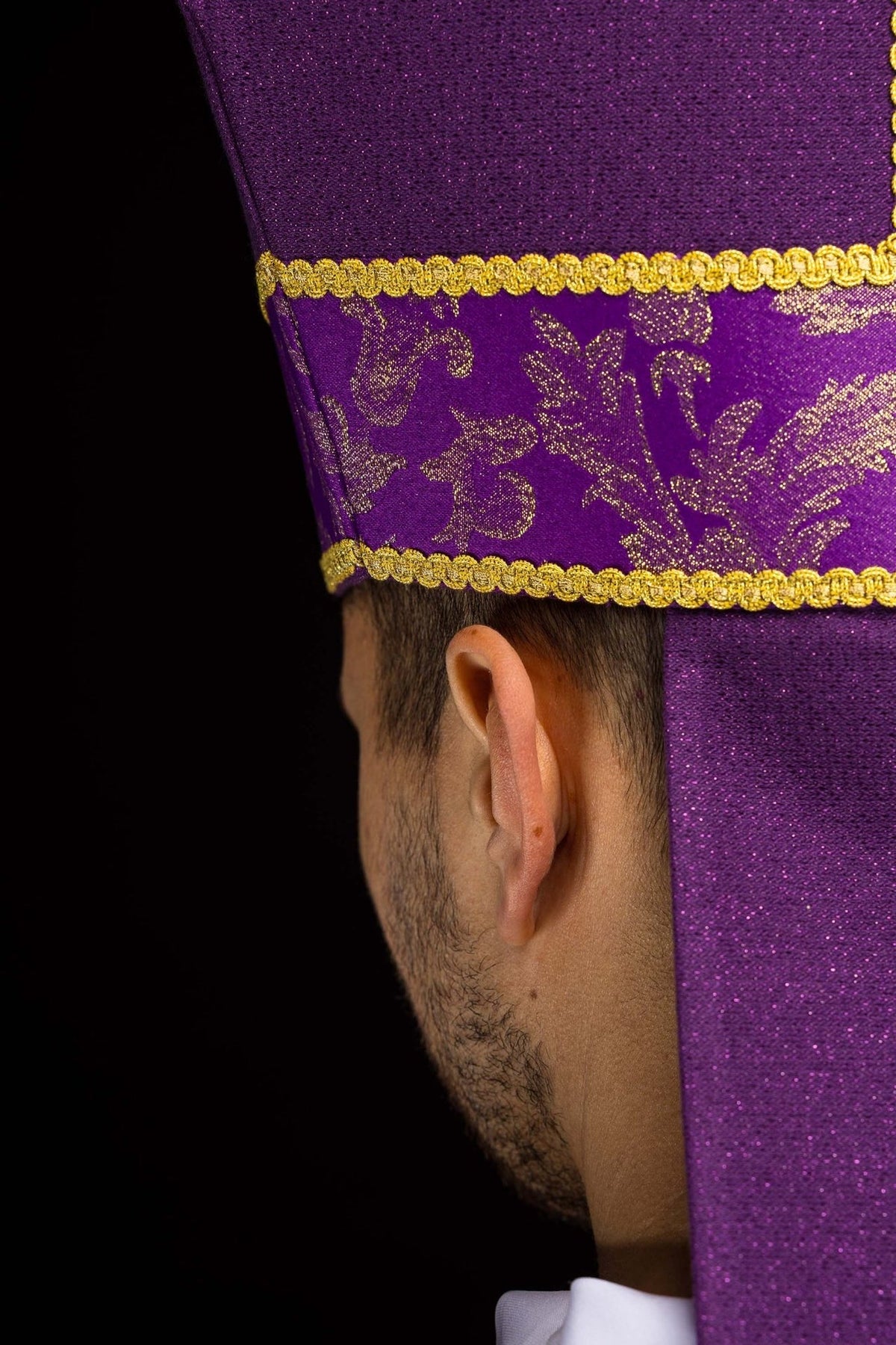 Purple miter close-up showing gold jacquard motifs and trim