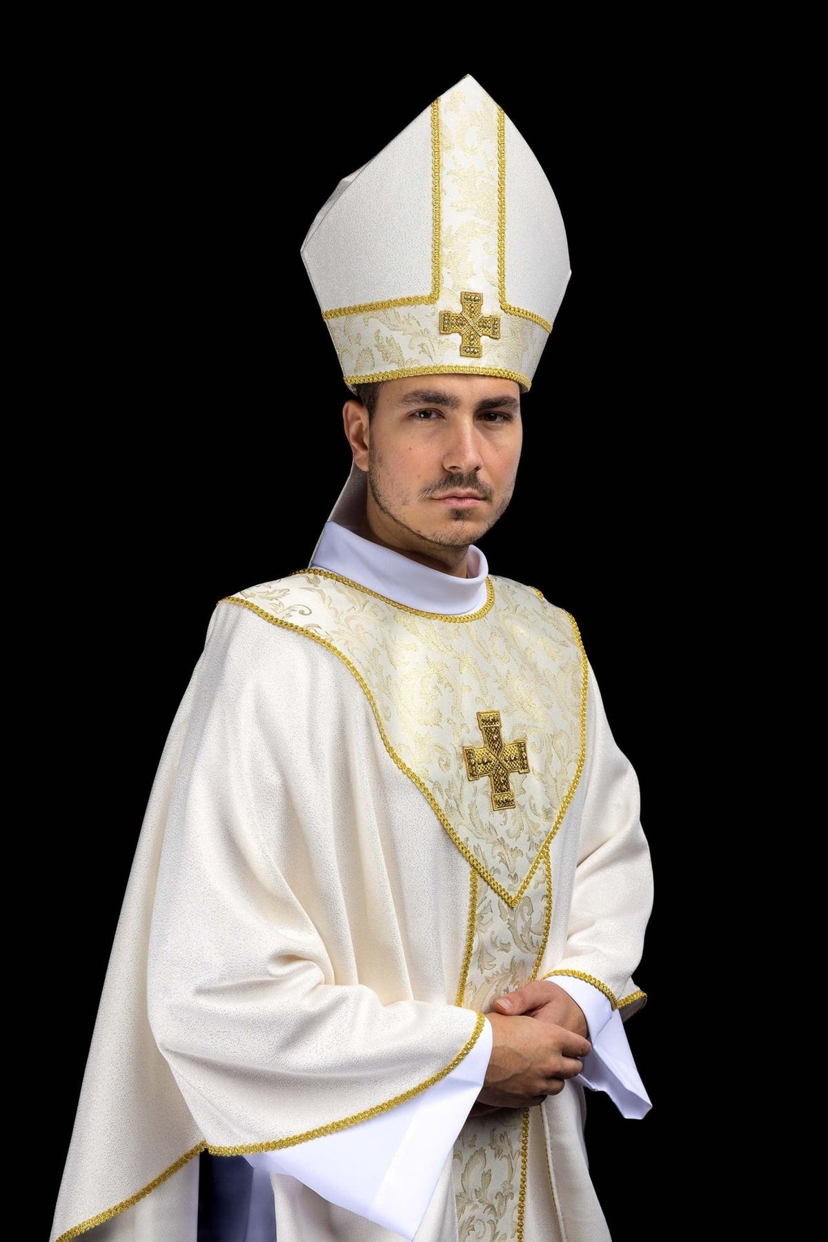 Ecru miter worn in a three-quarter view with embroidered cross
