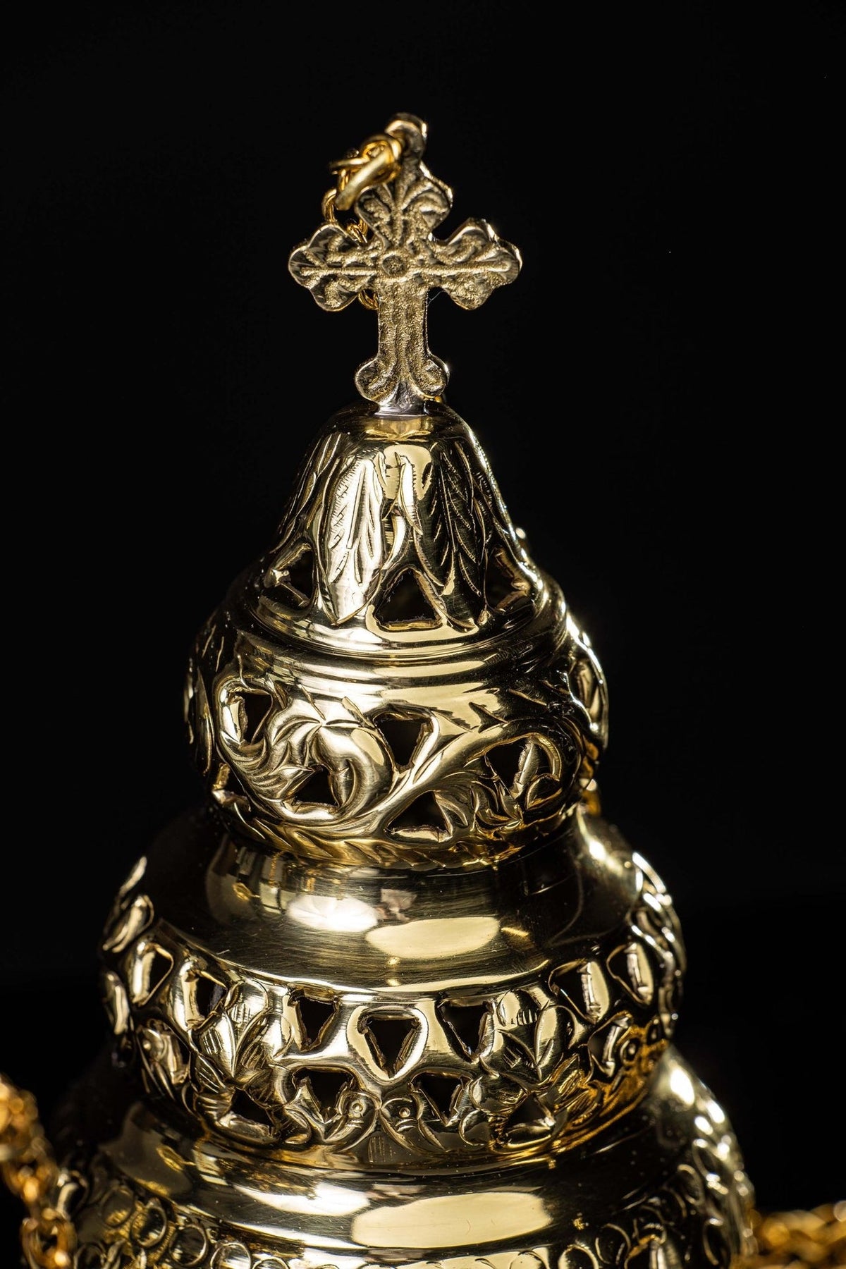 Brass thurible close-up of the ornate lid and cross